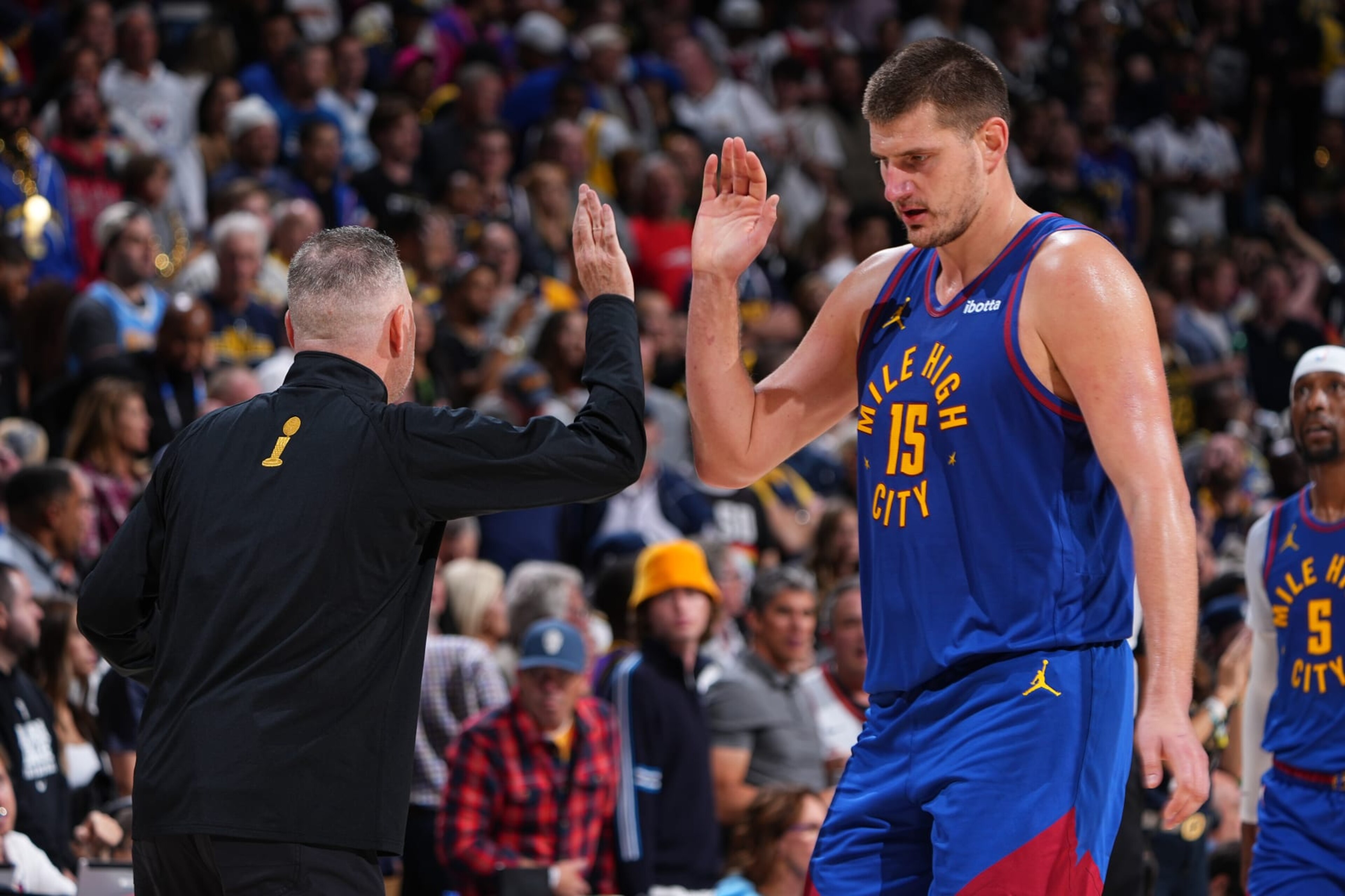 DENVER, CO - OCTOBER 24: Michael Malone and Nikola Jokic #15 of the Denver Nuggets shake hands against the Los Angeles Lakers on October 24, 2023 at the Ball Arena in Denver, Colorado. NOTE TO USER: User expressly acknowledges and agrees that, by downloading and/or using this Photograph, user is consenting to the terms and conditions of the Getty Images License Agreement. Mandatory Copyright Notice: Copyright 2023 NBAE (Photo by Garrett Ellwood/NBAE via Getty Images)
