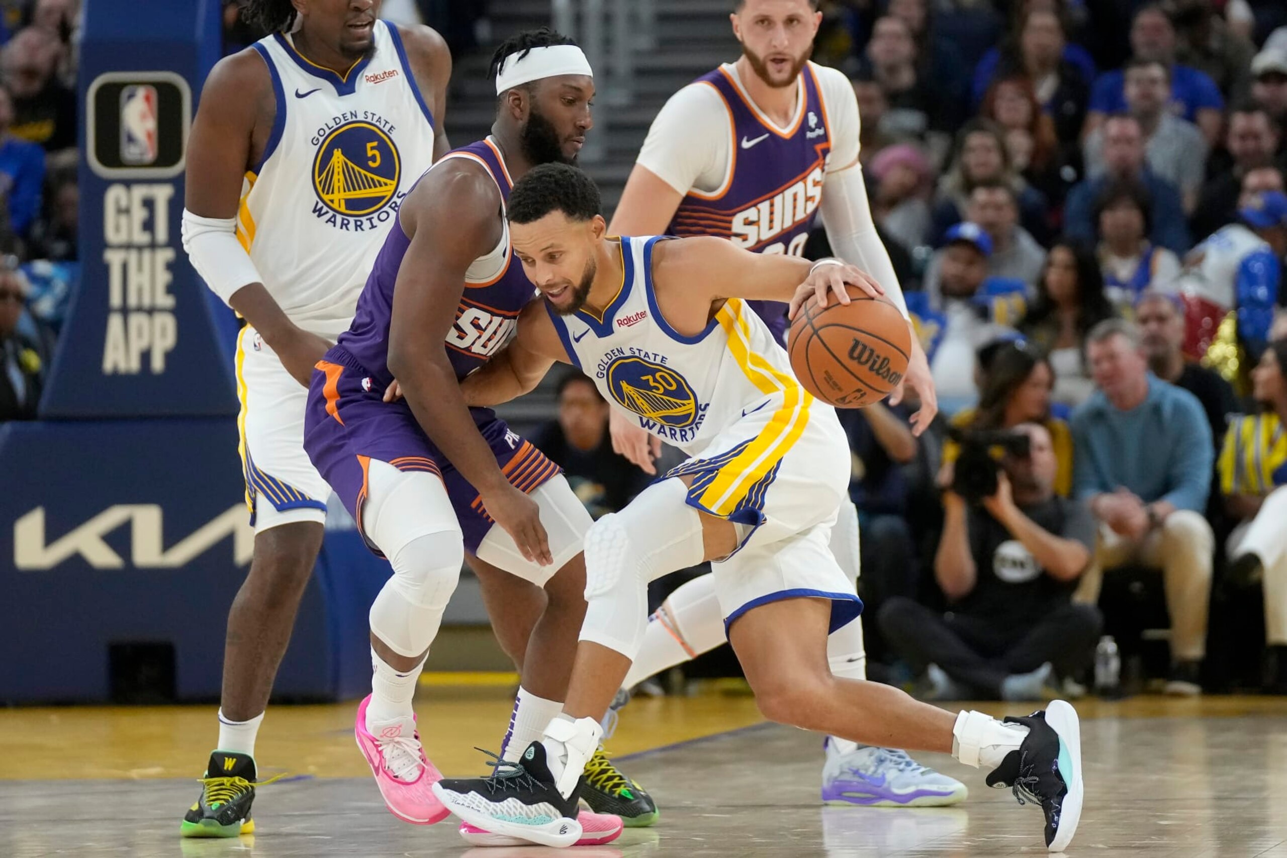 Golden State Warriors guard Stephen Curry (30) is defended by Phoenix Suns forward Josh Okogie during the first half of an NBA basketball game in San Francisco, Tuesday, Oct. 24, 2023. (AP Photo/Jeff Chiu)