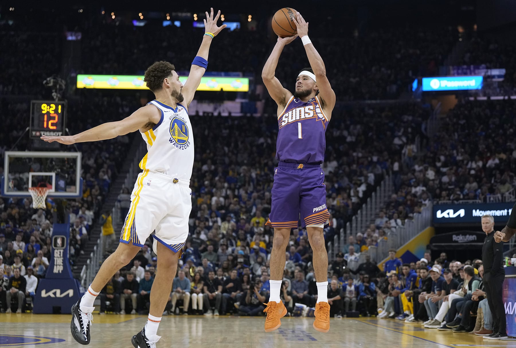 SAN FRANCISCO, CALIFORNIA - OCTOBER 24: Devin Booker #1 of the Phoenix Suns shoots over Klay Thompson #11 of the Golden State Warriors during the first quarter at Chase Center on October 24, 2023 in San Francisco, California. NOTE TO USER: User expressly acknowledges and agrees that, by downloading and or using this photograph, User is consenting to the terms and conditions of the Getty Images License Agreement. (Photo by Thearon W. Henderson/Getty Images)