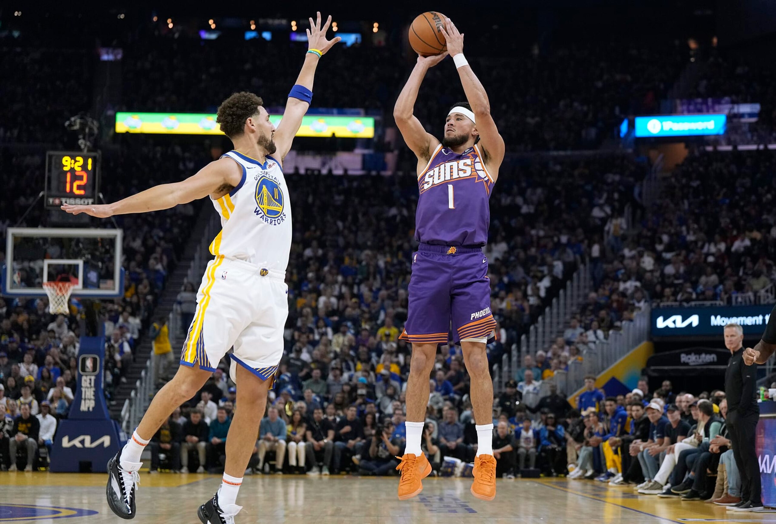 SAN FRANCISCO, CALIFORNIA - OCTOBER 24: Devin Booker #1 of the Phoenix Suns shoots over Klay Thompson #11 of the Golden State Warriors during the first quarter at Chase Center on October 24, 2023 in San Francisco, California. NOTE TO USER: User expressly acknowledges and agrees that, by downloading and or using this photograph, User is consenting to the terms and conditions of the Getty Images License Agreement. (Photo by Thearon W. Henderson/Getty Images)
