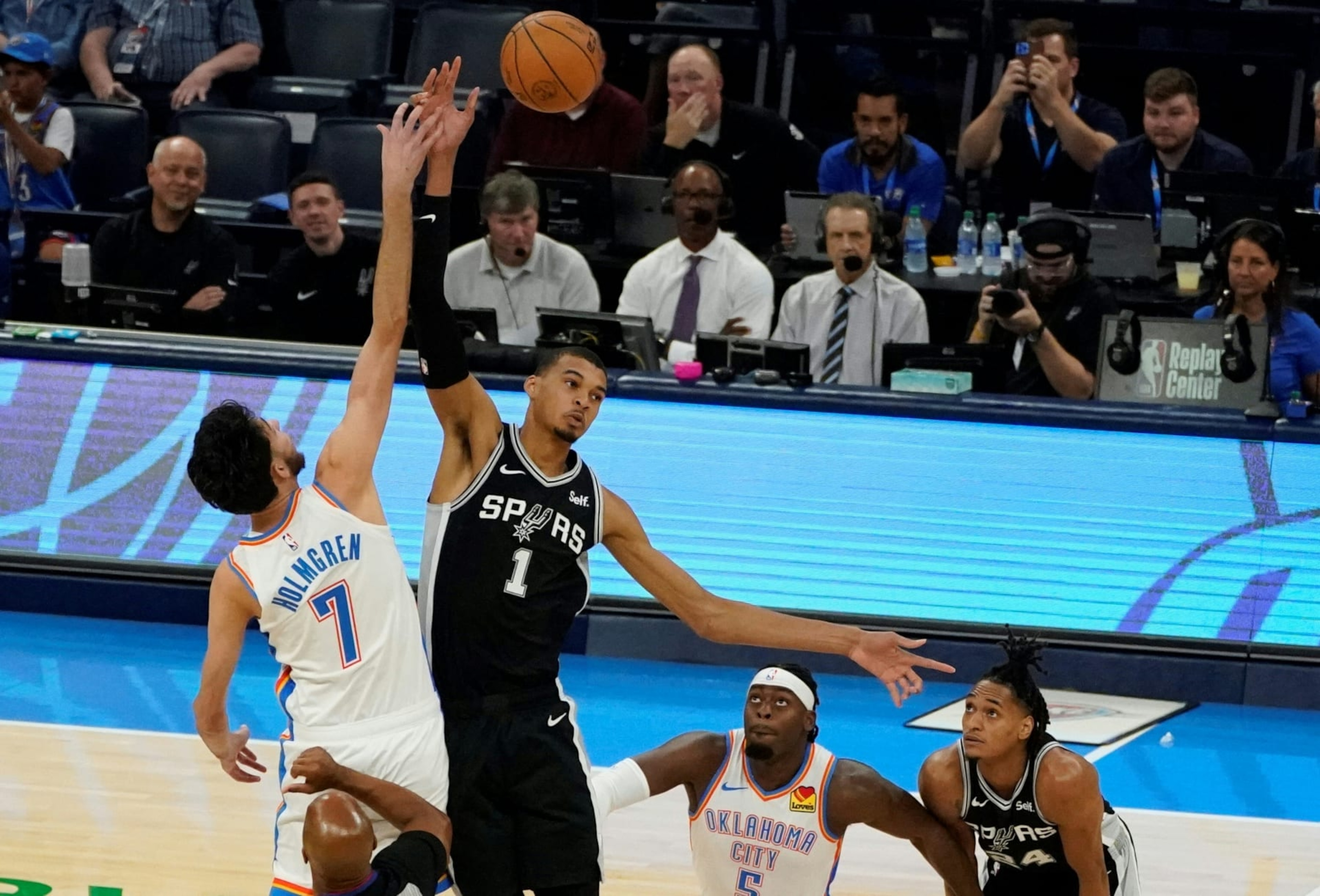 San Antonio Spurs French center #01 Victor Wembanyama and Oklahoma City Thunder's US power forward #07 Chet Holmgren reach for the ball during the NBA pre-season basketball game between San Antonio Spurs and Oklahoma City Thunder at Paycom Center arena in Oklahoma City, Oklahoma, on October 9, 2023. (Photo by TIMOTHY A. CLARY / AFP) (Photo by TIMOTHY A. CLARY/AFP via Getty Images) San Antonio Spurs French center #01 Victor Wembanyama and Oklahoma City Thunder's US power forward #07 Chet Holmgren reach for the ball during the NBA pre-season basketball game between San Antonio Spurs and Oklahoma City Thunder at Paycom Center arena in Oklahoma City, Oklahoma, on October 9, 2023. (Photo by TIMOTHY A. CLARY / AFP) (Photo by TIMOTHY A. CLARY/AFP via Getty Images)
