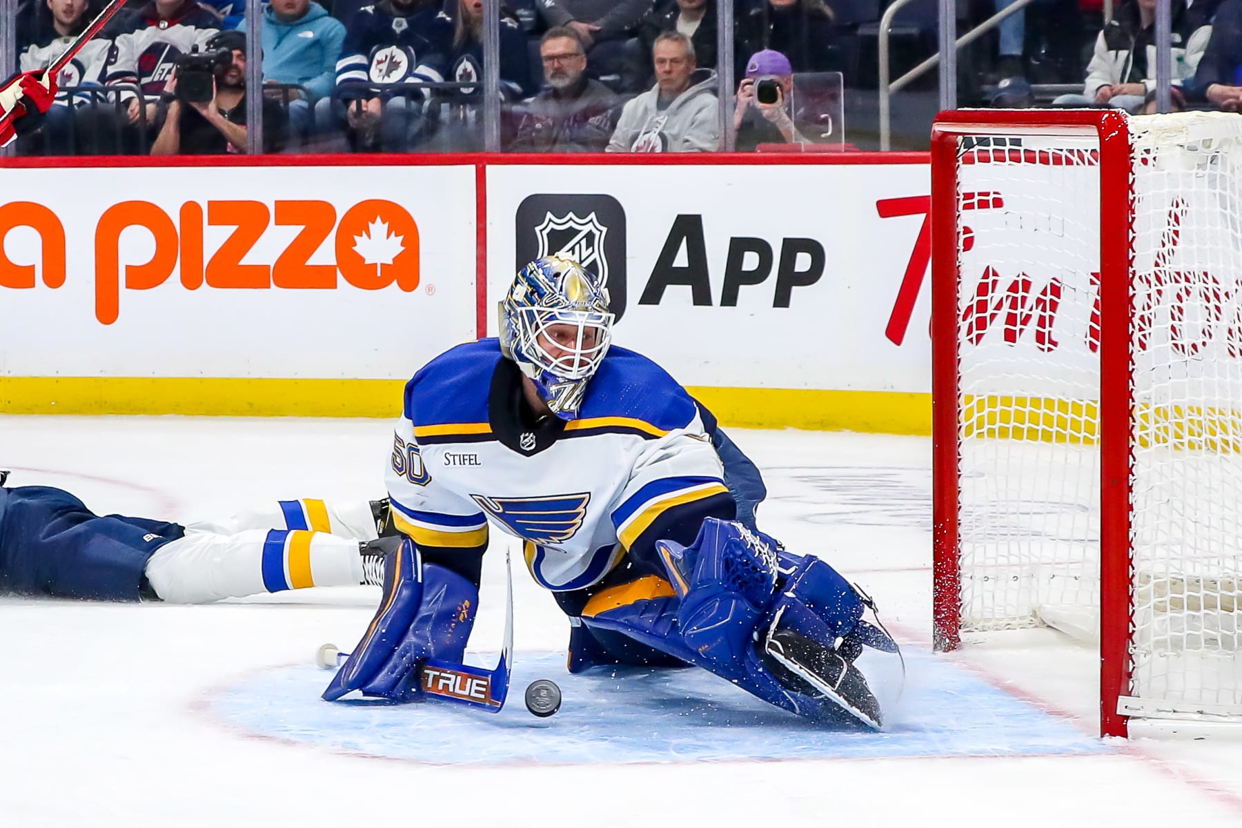 WINNIPEG, CANADA - JANUARY 30: Goaltender Jordan Binnington #50 of the St. Louis Blues makes a pad save during first period action against the Winnipeg Jets at the Canada Life Centre on January 30, 2023 in Winnipeg, Manitoba, Canada. (Photo by Darcy Finley/NHLI via Getty Images)