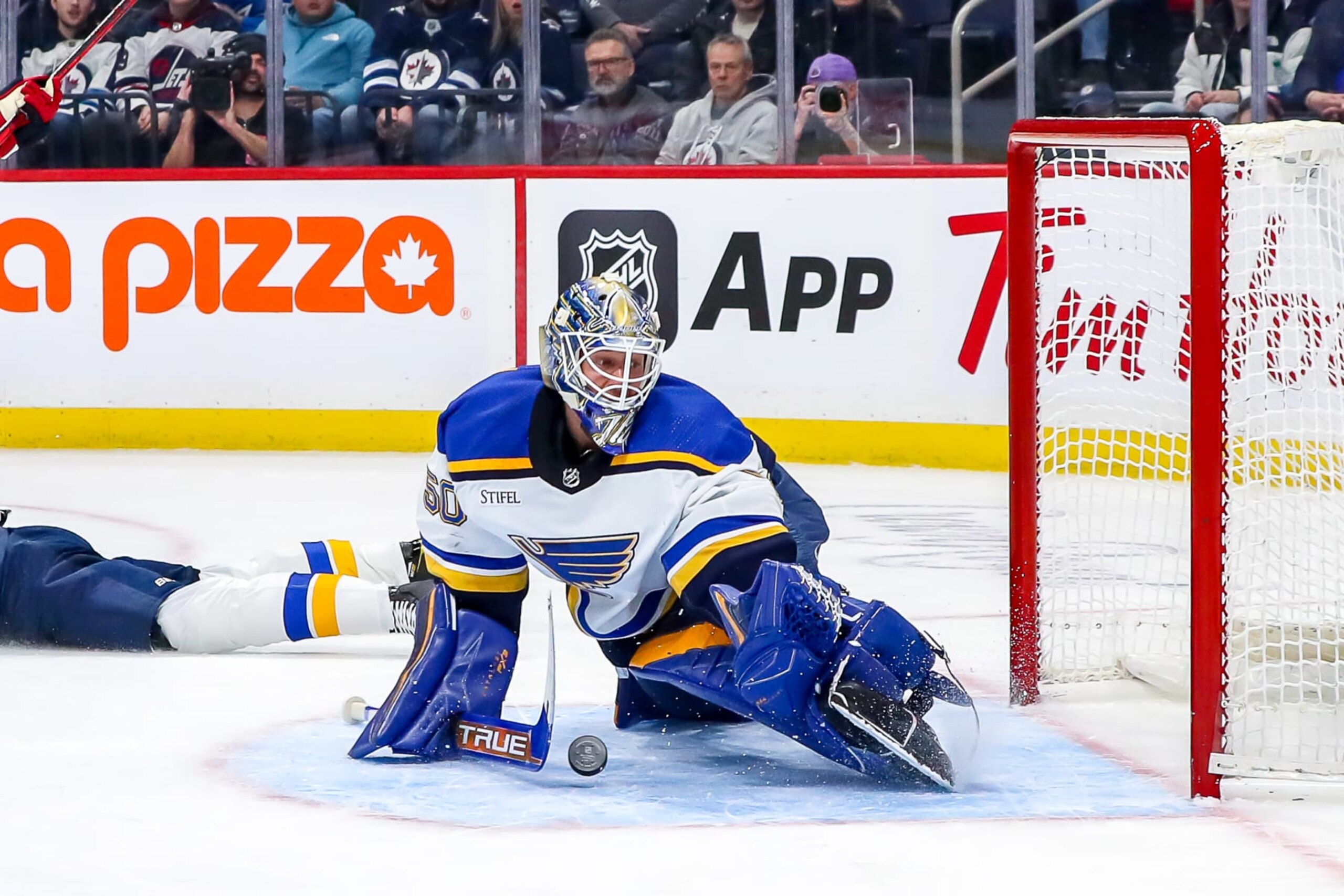 WINNIPEG, CANADA - JANUARY 30: Goaltender Jordan Binnington #50 of the St. Louis Blues makes a pad save during first period action against the Winnipeg Jets at the Canada Life Centre on January 30, 2023 in Winnipeg, Manitoba, Canada. (Photo by Darcy Finley/NHLI via Getty Images)
