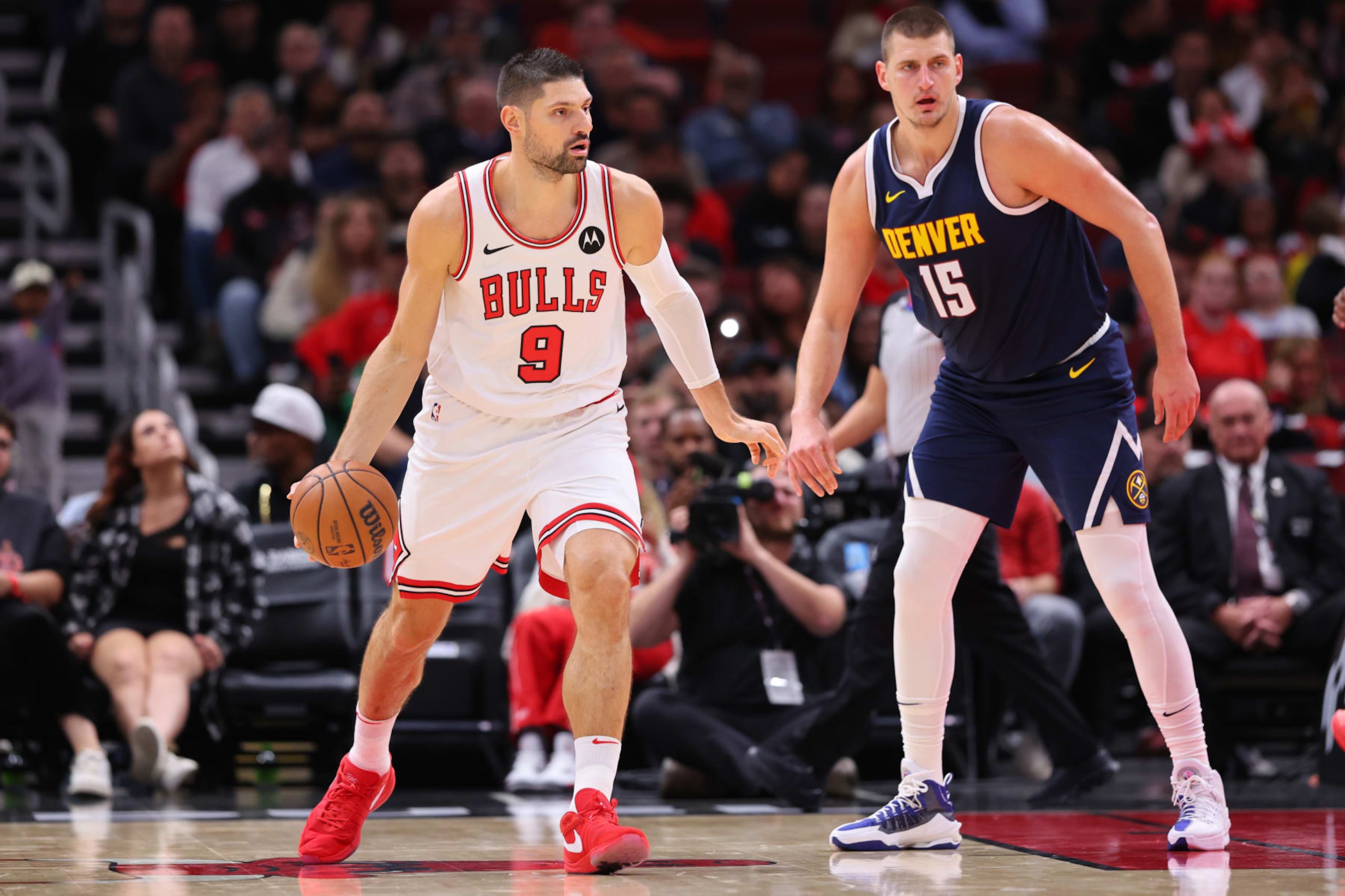 CHICAGO, ILLINOIS - OCTOBER 12: Nikola Vucevic #9 of the Chicago Bulls is defended by Nikola Jokic #15 of the Denver Nuggets during the first half at the United Center on October 12, 2023 in Chicago, Illinois. NOTE TO USER: User expressly acknowledges and agrees that, by downloading and or using this photograph, User is consenting to the terms and conditions of the Getty Images License Agreement.  (Photo by Michael Reaves/Getty Images)