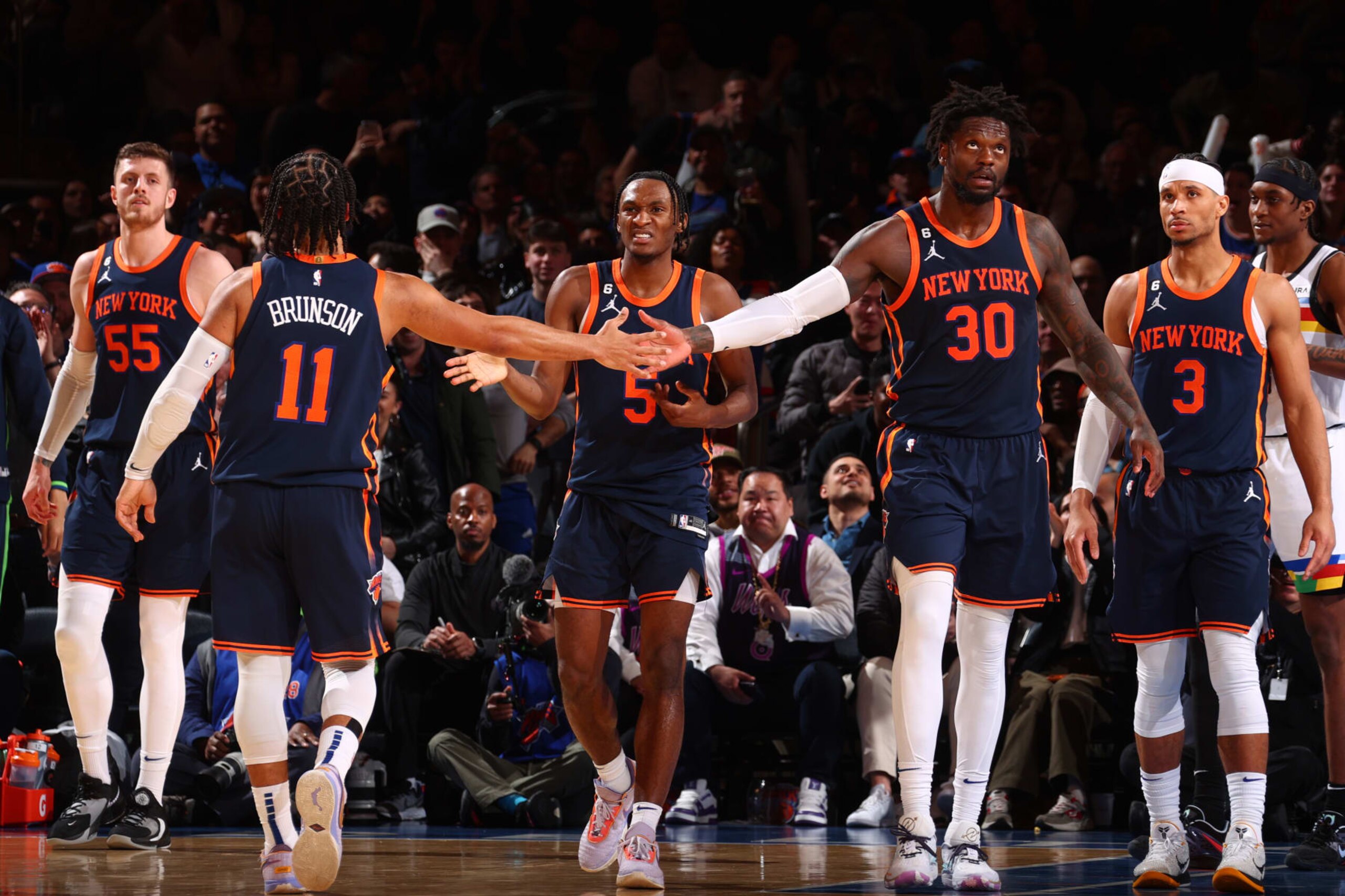 NEW YORK, NY - MARCH 20:  Jalen Brunson #11 and Julius Randle #30 of the New York Knicks high fives during the game on March 20, 2023 at Madison Square Garden in New York City, New York.  NOTE TO USER: User expressly acknowledges and agrees that, by downloading and or using this photograph, User is consenting to the terms and conditions of the Getty Images License Agreement. Mandatory Copyright Notice: Copyright 2023 NBAE  (Photo by Nathaniel S. Butler/NBAE via Getty Images)