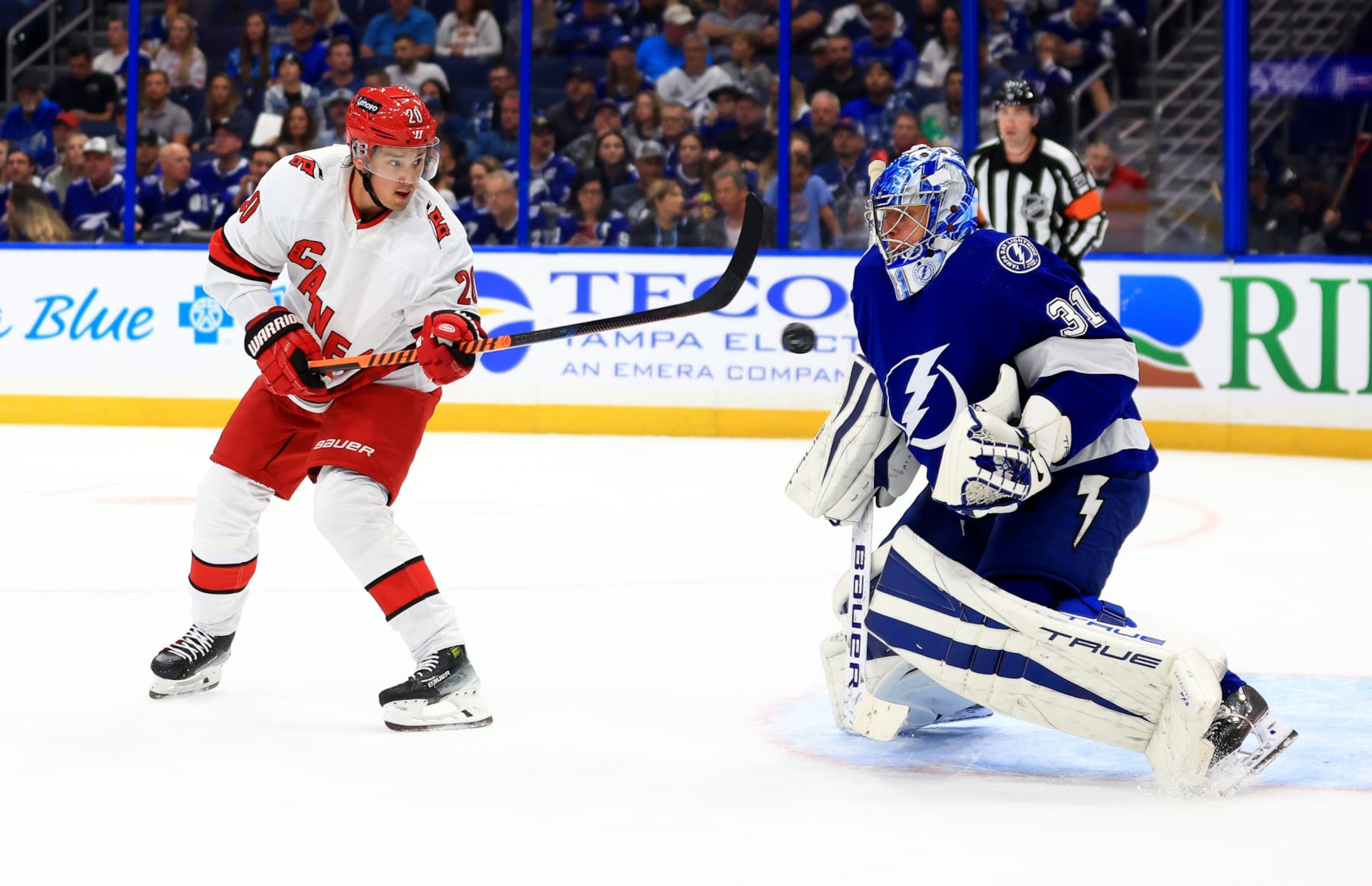 TAMPA, FLORIDA - OCTOBER 24: Jonas Johansson #31 of the Tampa Bay Lightning stops a shot from Sebastian Aho #20 of the Carolina Hurricanes in the first period during a game  at Amalie Arena on October 24, 2023 in Tampa, Florida. (Photo by Mike Ehrmann/Getty Images)
