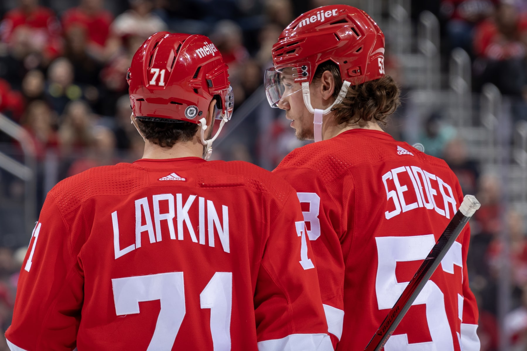 DETROIT, MI - OCTOBER 24: Dylan Larkin #71 of the Detroit Red Wings talks to Moritz Seider #53 before a face off against the Seattle Kraken during the third period at Little Caesars Arena on October 24, 2023 in Detroit, Michigan. Seattle defeated Detroit 5-4. (Photo by Dave Reginek/NHLI via Getty Images)
