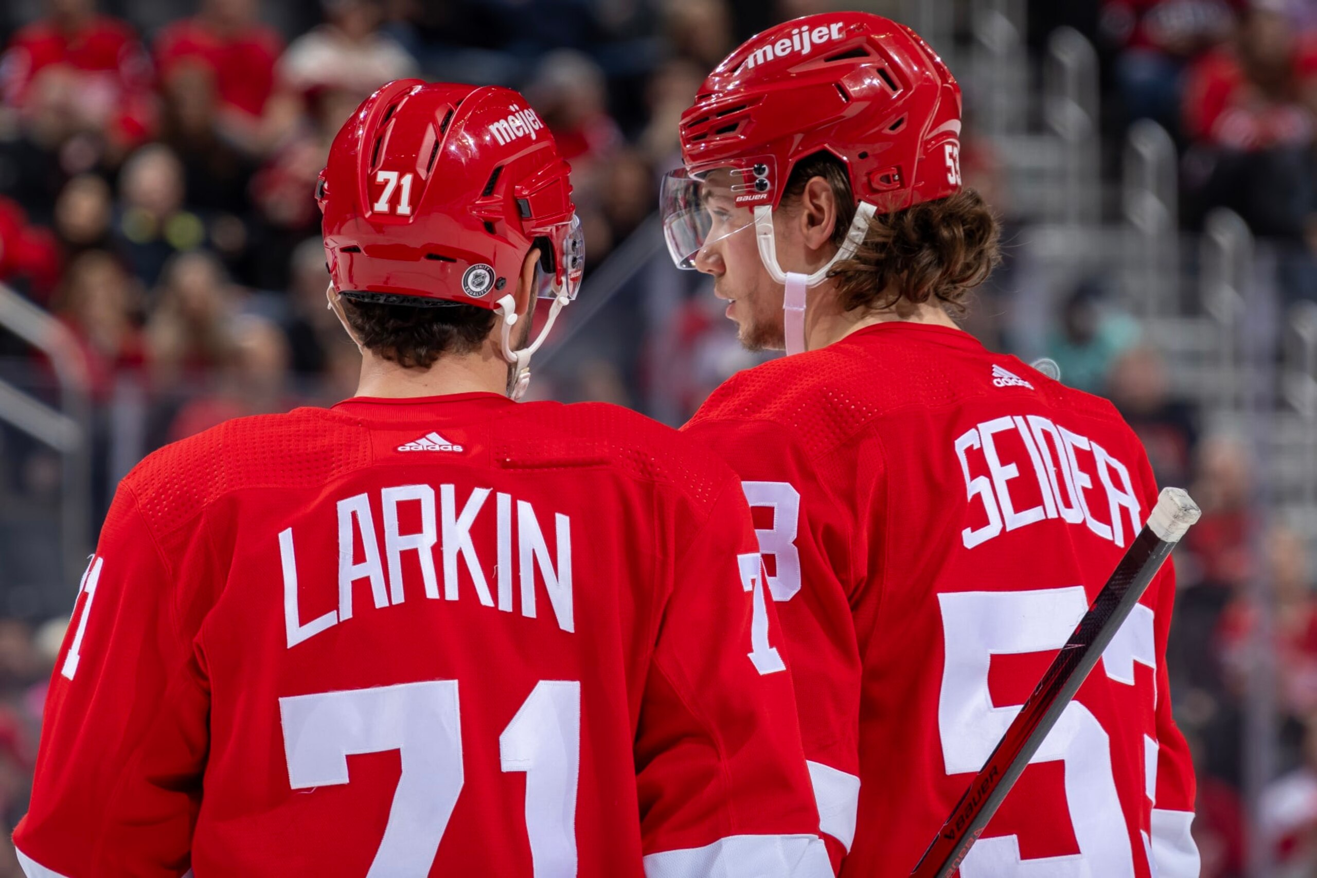 DETROIT, MI - OCTOBER 24: Dylan Larkin #71 of the Detroit Red Wings talks to Moritz Seider #53 before a face off against the Seattle Kraken during the third period at Little Caesars Arena on October 24, 2023 in Detroit, Michigan. Seattle defeated Detroit 5-4. (Photo by Dave Reginek/NHLI via Getty Images)