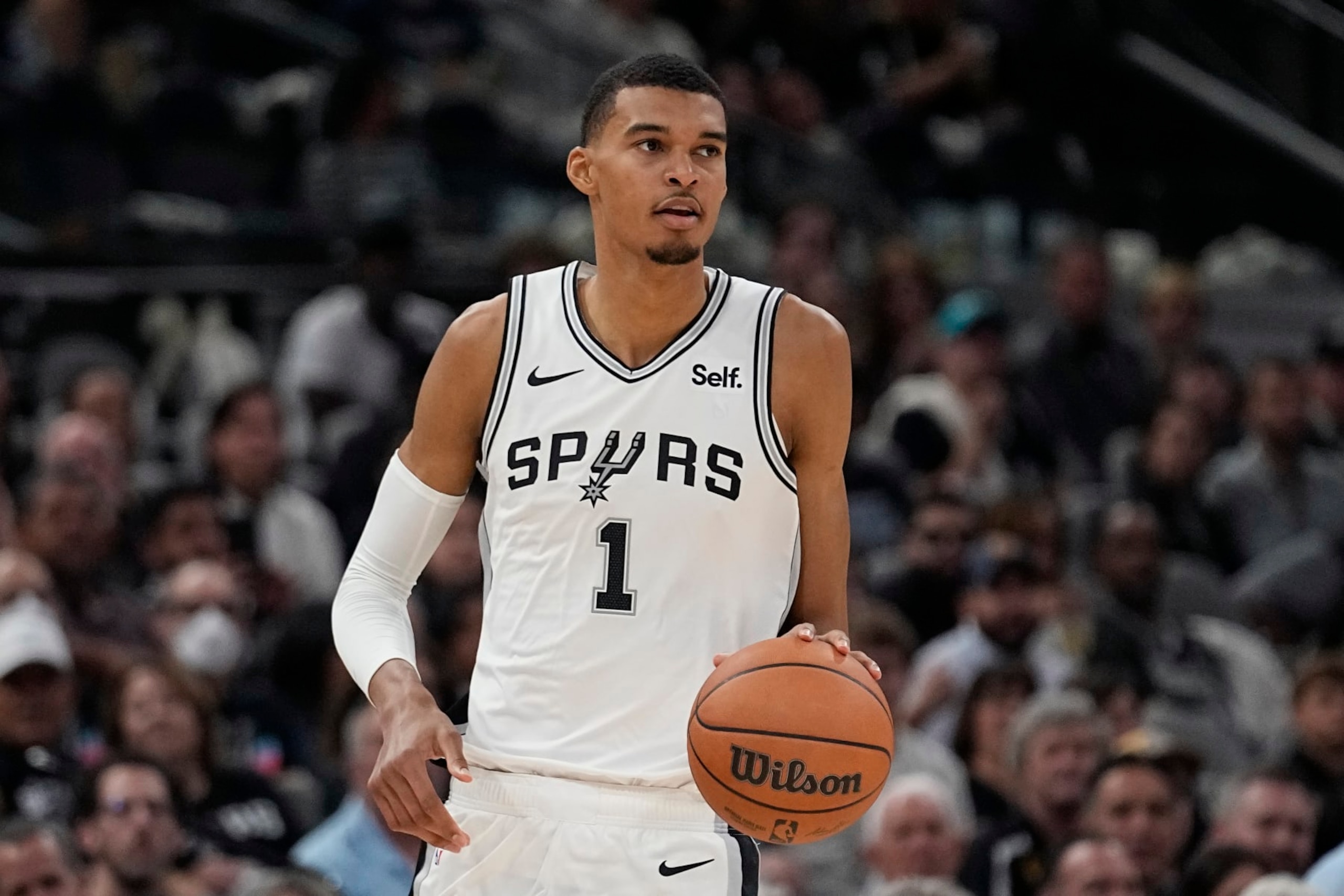San Antonio Spurs center Victor Wembanyama brings the ball up against the Dallas Mavericks during the second half of an NBA basketball game in San Antonio, Wednesday, Oct. 25, 2023. (AP Photo/Eric Gay)