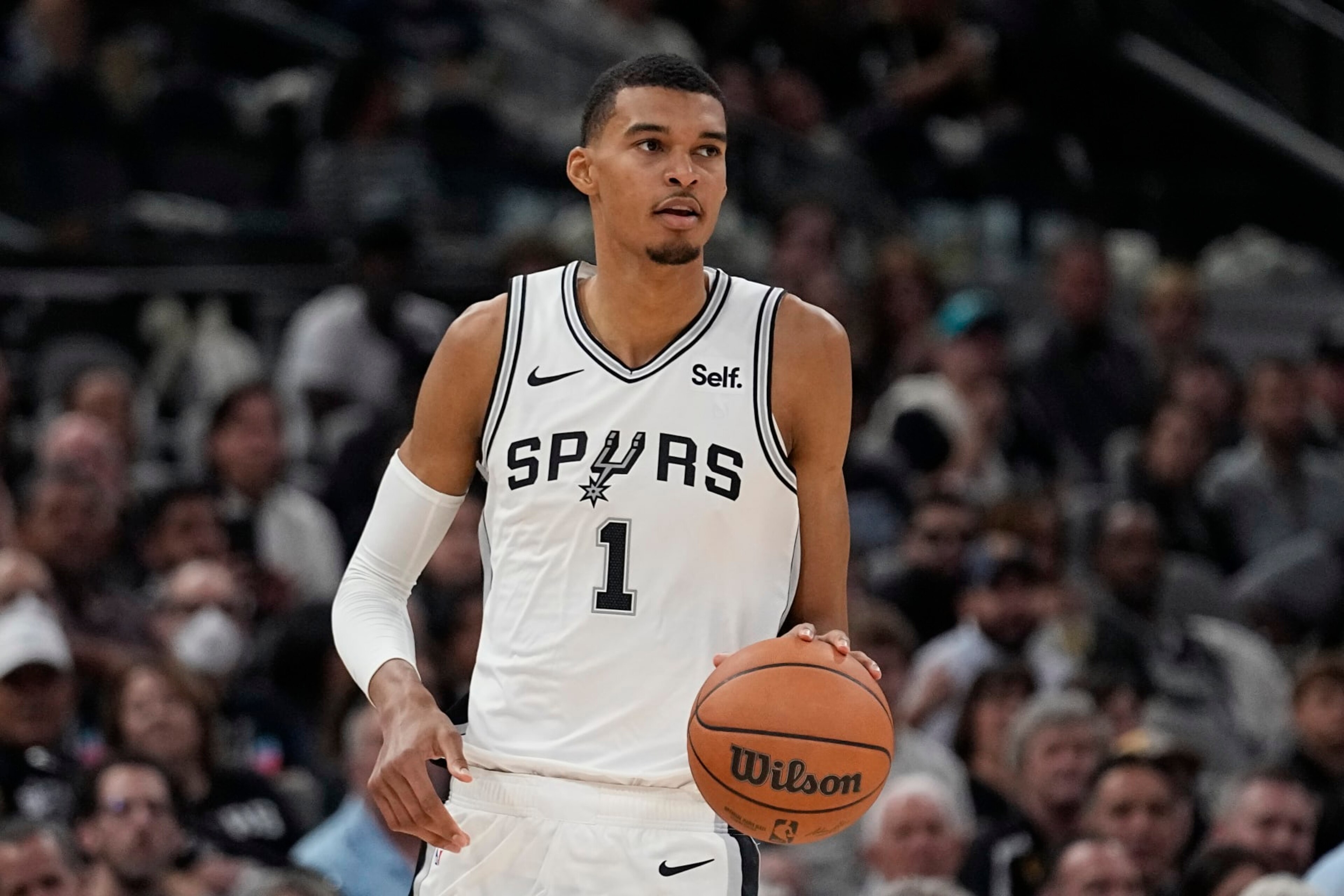San Antonio Spurs center Victor Wembanyama brings the ball up against the Dallas Mavericks during the second half of an NBA basketball game in San Antonio, Wednesday, Oct. 25, 2023. (AP Photo/Eric Gay)
