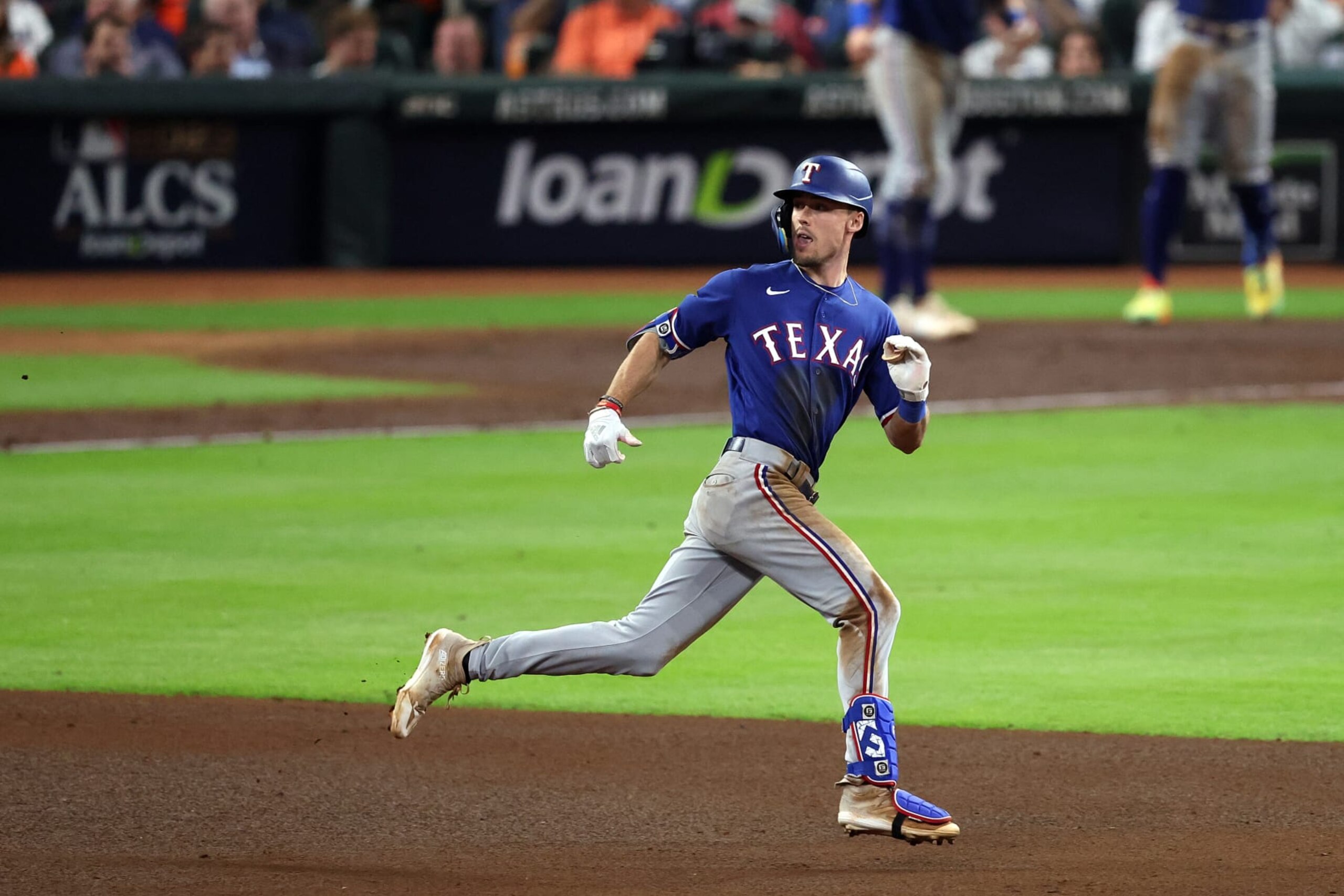 HOUSTON, TEXAS - OCTOBER 23: Evan Carter #32 of the Texas Rangers runs to second base after hitting an RBI double to score Josh Jung #6 and Marcus Semien #2 against the Houston Astros during the fourth inning in Game Seven of the American League Championship Series at Minute Maid Park on October 23, 2023 in Houston, Texas. (Photo by Rob Carr/Getty Images)