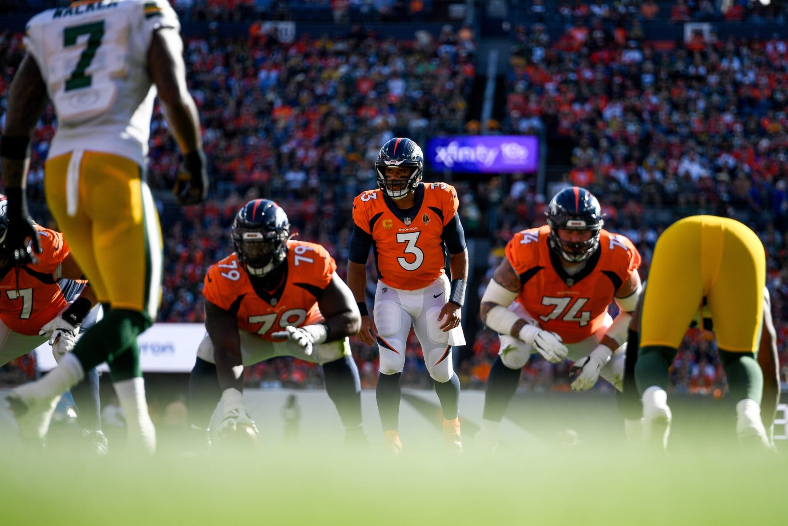 DENVER, COLORADO - OCTOBER 22:  Quarterback Russell Wilson #3 of the Denver Broncos lines up behind center Lloyd Cushenberry #79 and guard Ben Powers #74 in the first quarter against the Green Bay Packers at Empower Field at Mile High on October 22, 2023 in Denver, Colorado. (Photo by Dustin Bradford/Getty Images)