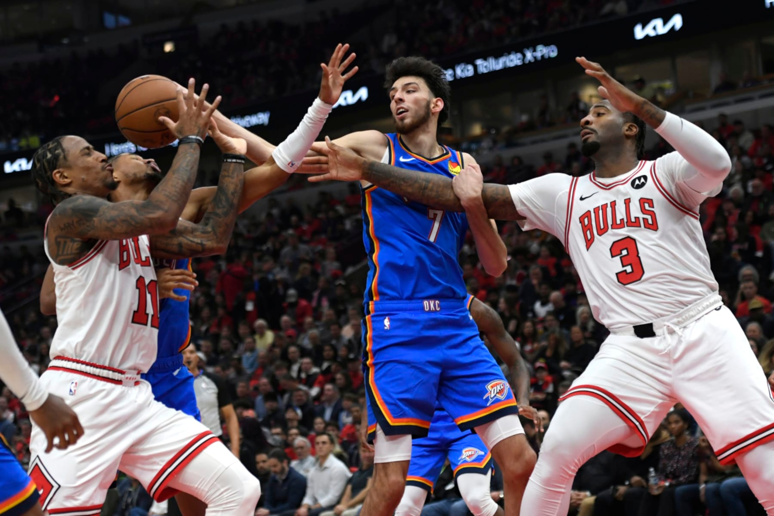 Chicago Bulls' DeMar DeRozan (11) and Andre Drummond (3) battle Oklahoma City Thunder's Chet Holmgren (7) and Isaiah Joe, second from left, for a rebound during the first half of an NBA basketball game Wednesday, Oct. 25, 2023, in Chicago. (AP Photo/Paul Beaty)