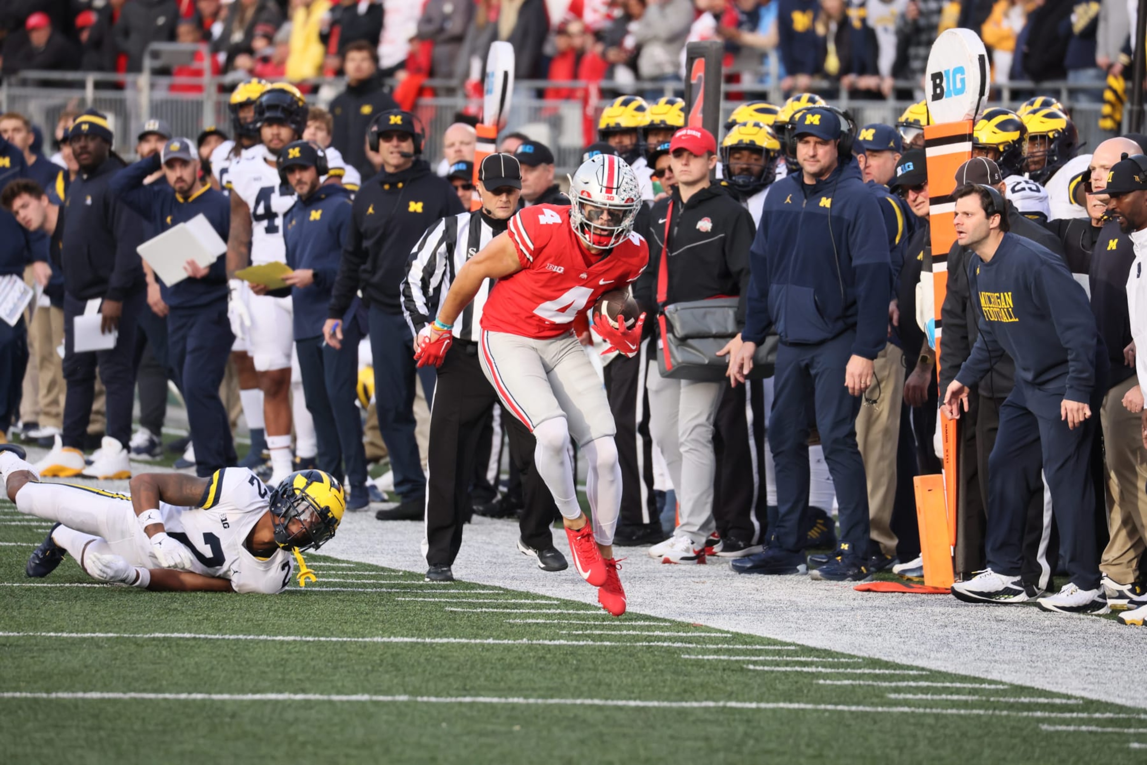 College Football: Ohio State Julian Fleming (4) in action, runs with the football vs Michigan at Ohio Stadium. Football analyst Connor Stalions and head coach Jim Harbaugh present in the background. Columbus, OH 11/26/2022CREDIT: David E. Klutho (Photo by David E. Klutho/Sports Illustrated via Getty Images) (Set Number: X164248 TK1) College Football: Ohio State Julian Fleming (4) in action, runs with the football vs Michigan at Ohio Stadium. Football analyst Connor Stalions and head coach Jim Harbaugh present in the background. Columbus, OH 11/26/2022CREDIT: David E. Klutho (Photo by David E. Klutho/Sports Illustrated via Getty Images) (Set Number: X164248 TK1)