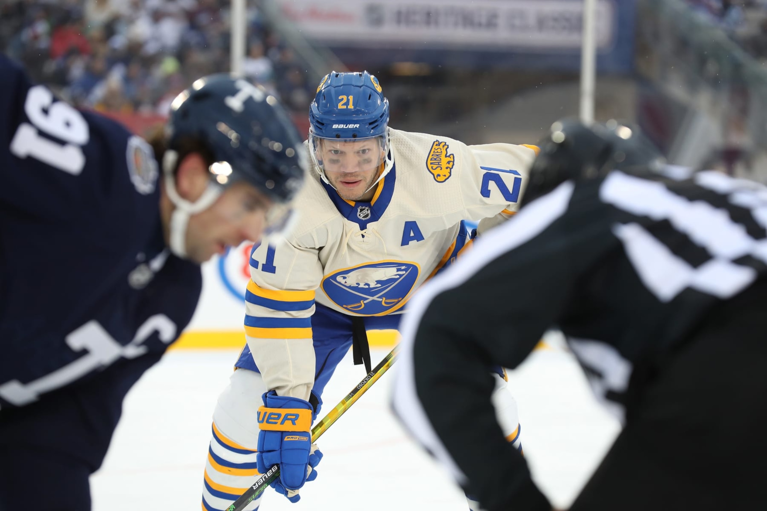 HAMILTON, ONTARIO - MARCH 13: Kyle Okposo #21 of the Buffalo Sabres eyes the face off against the Buffalo Sabres in the third period during the Heritage Classic at Tim Hortons Field on March 13, 2022 in Hamilton, Ontario. (Photo by Claus Andersen/Getty Images) HAMILTON, ONTARIO - MARCH 13: Kyle Okposo #21 of the Buffalo Sabres eyes the face off against the Buffalo Sabres in the third period during the Heritage Classic at Tim Hortons Field on March 13, 2022 in Hamilton, Ontario. (Photo by Claus Andersen/Getty Images)