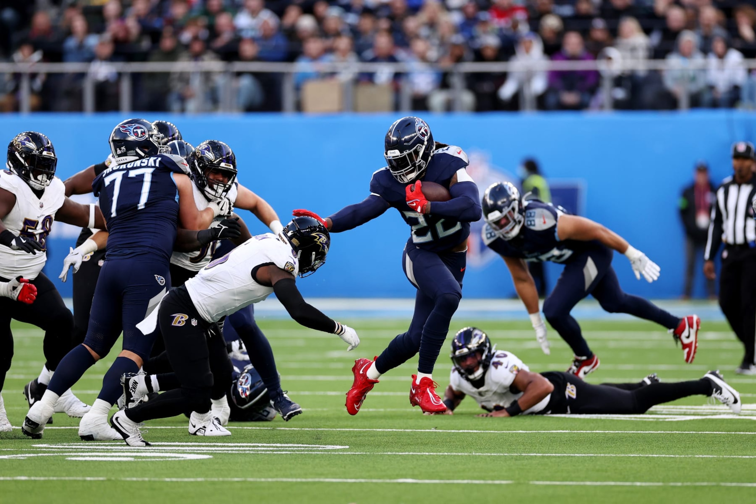 LONDON, ENGLAND - OCTOBER 15: Derrick Henry #22 of the Tennessee Titans stiff arms Patrick Queen #6 of the Baltimore Ravens in the third quarter during the 2023 NFL London Games match between Baltimore Ravens and Tennessee Titans at Tottenham Hotspur Stadium on October 15, 2023 in London, England. (Photo by Ryan Pierse/Getty Images)