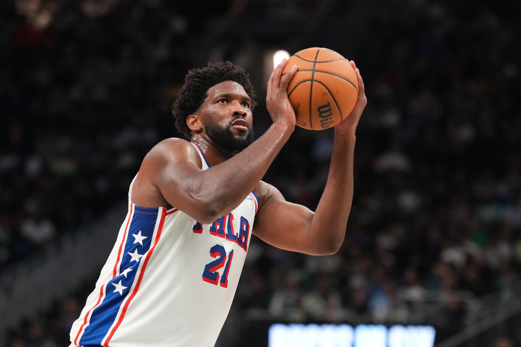 MILWAUKEE, WI - OCTOBER 26: Joel Embiid #21 of the Philadelphia 76ers shoots a free throw during the game against the Milwaukee Bucks on October 26, 2023 at the Fiserv Forum Center in Milwaukee, Wisconsin. NOTE TO USER: User expressly acknowledges and agrees that, by downloading and or using this Photograph, user is consenting to the terms and conditions of the Getty Images License Agreement. Mandatory Copyright Notice: Copyright 2023 NBAE (Photo by Jesse D. Garrabrant/NBAE via Getty Images).