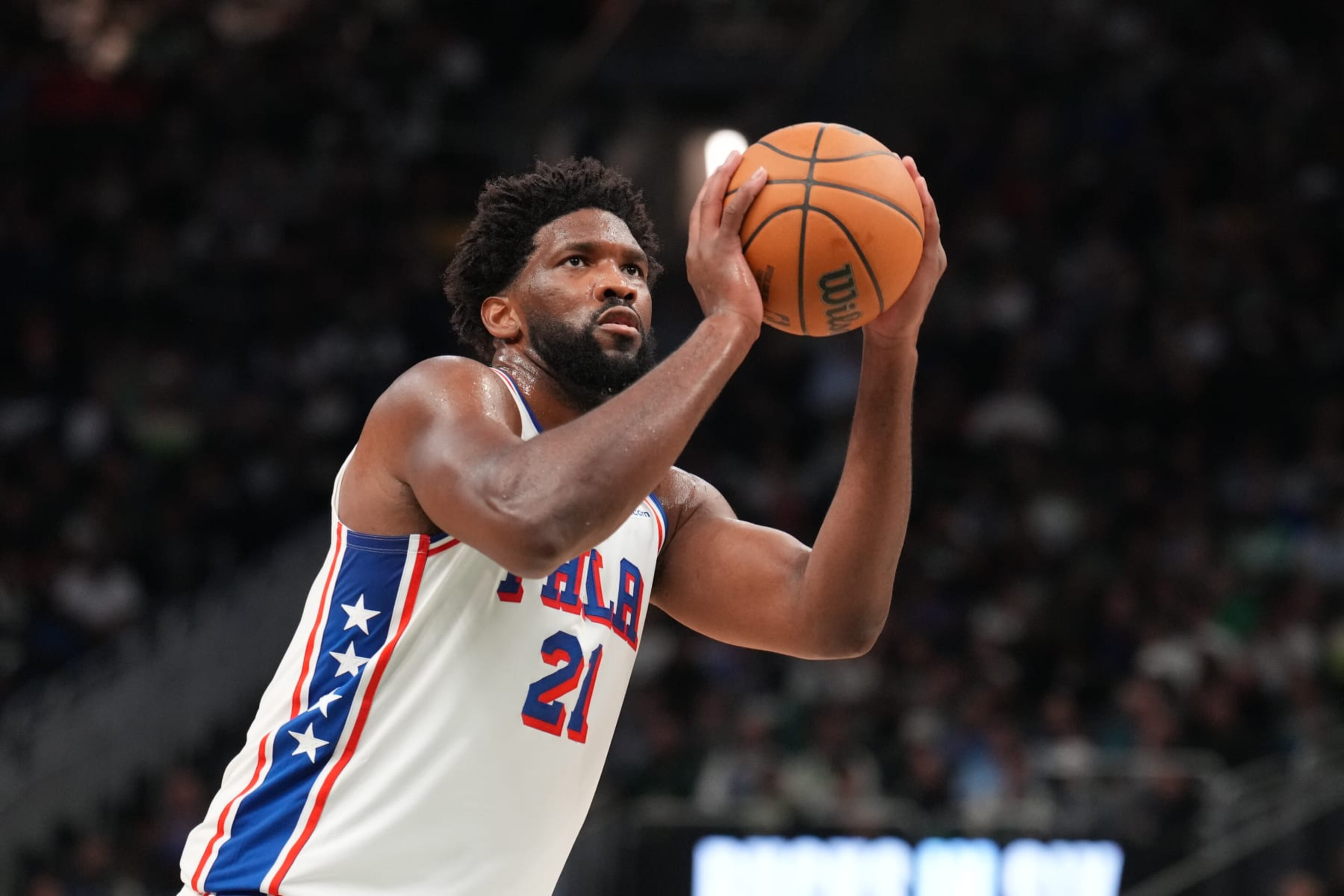 MILWAUKEE, WI - OCTOBER 26: Joel Embiid #21 of the Philadelphia 76ers shoots a free throw during the game against the Milwaukee Bucks on October 26, 2023 at the Fiserv Forum Center in Milwaukee, Wisconsin. NOTE TO USER: User expressly acknowledges and agrees that, by downloading and or using this Photograph, user is consenting to the terms and conditions of the Getty Images License Agreement. Mandatory Copyright Notice: Copyright 2023 NBAE (Photo by Jesse D. Garrabrant/NBAE via Getty Images).