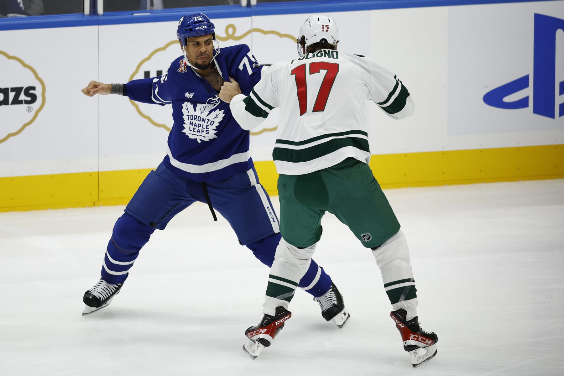 TORONTO. Toronto Maple Leafs Ryan Reaves ( l) fights Marco Folingo of the Minnesota Wild in a hard hitting first period. NHL action.(R.J.Johnston/Toronto Star)          (Photo R.J. Johnston Toronto Star/Toronto Star via Getty Images)