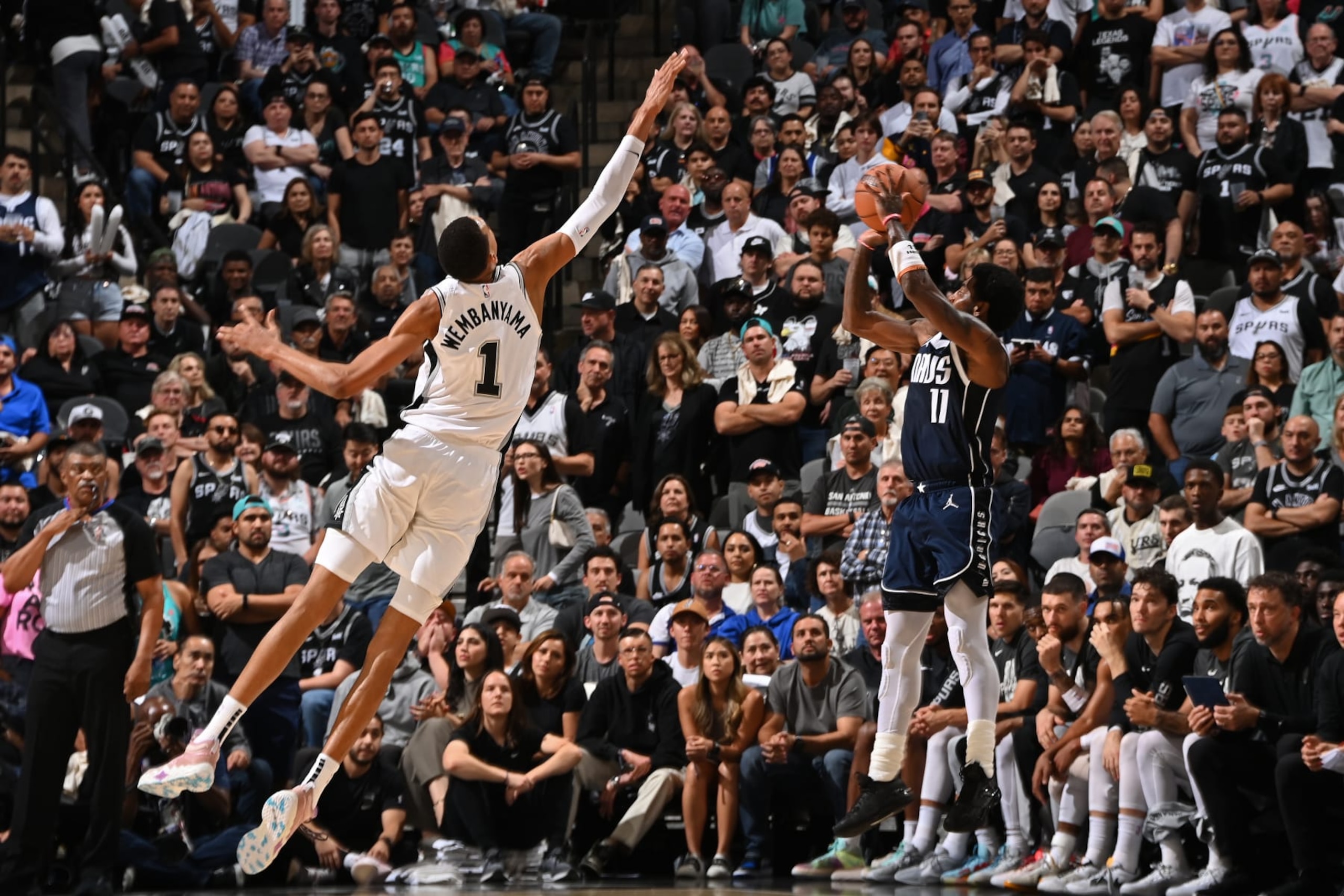 SAN ANTONIO, TX - OCTOBER 25: Victor Wembanyama #1 of the San Antonio Spurs plays defense against Kyrie Irving #11 of the Dallas Mavericks on October 25, 2023 at the Frost Bank Center in San Antonio, Texas. NOTE TO USER: User expressly acknowledges and agrees that, by downloading and or using this photograph, user is consenting to the terms and conditions of the Getty Images License Agreement. Mandatory Copyright Notice: Copyright 2023 NBAE (Photos by Andrew D. Bernstein/NBAE via Getty Images)