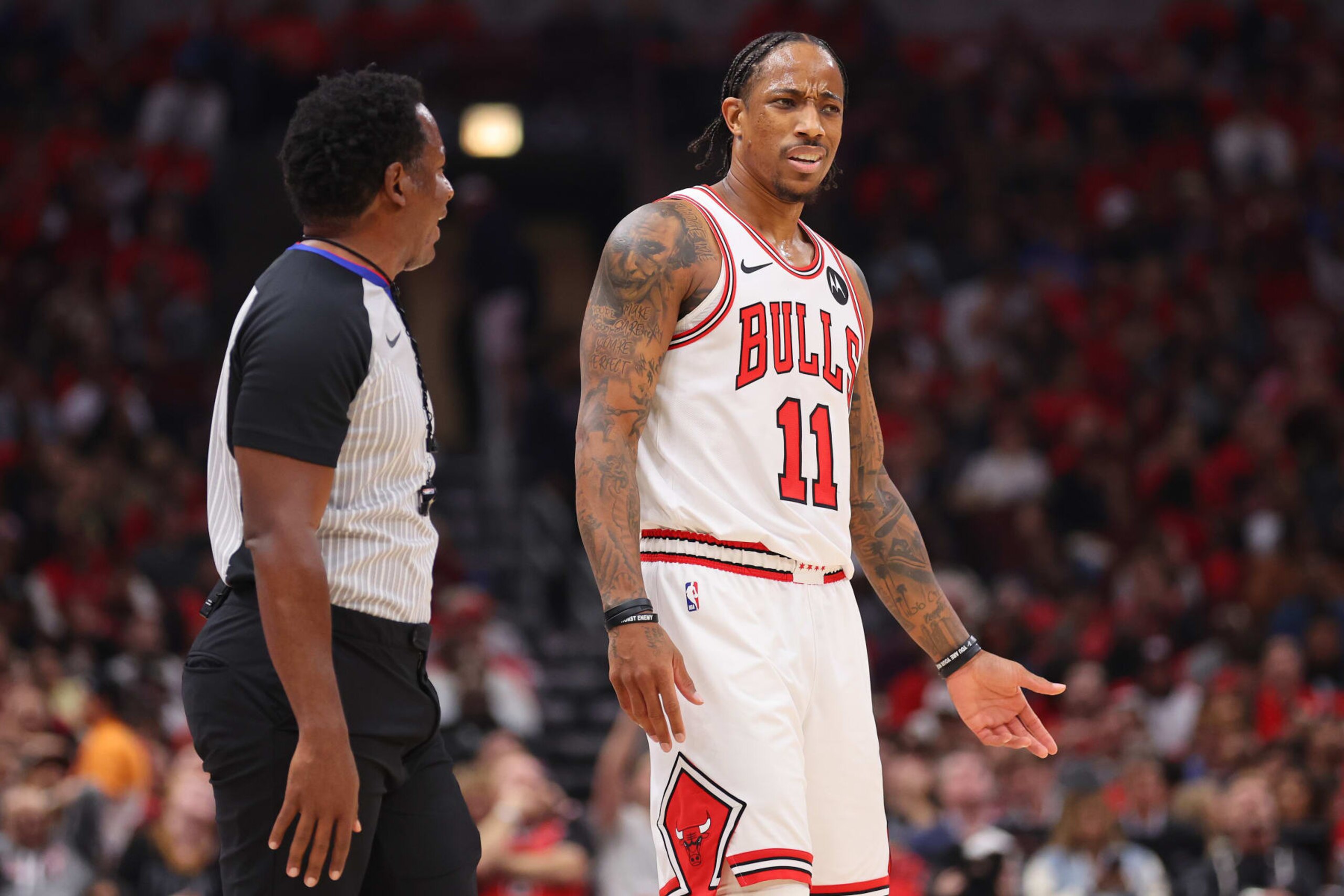 CHICAGO, ILLINOIS - OCTOBER 25: DeMar DeRozan #11 of the Chicago Bulls argues with referee Mitchell Ervin #27 against the Oklahoma City Thunder during the first half at the United Center on October 25, 2023 in Chicago, Illinois. NOTE TO USER: User expressly acknowledges and agrees that, by downloading and or using this photograph, User is consenting to the terms and conditions of the Getty Images License Agreement. (Photo by Michael Reaves/Getty Images)