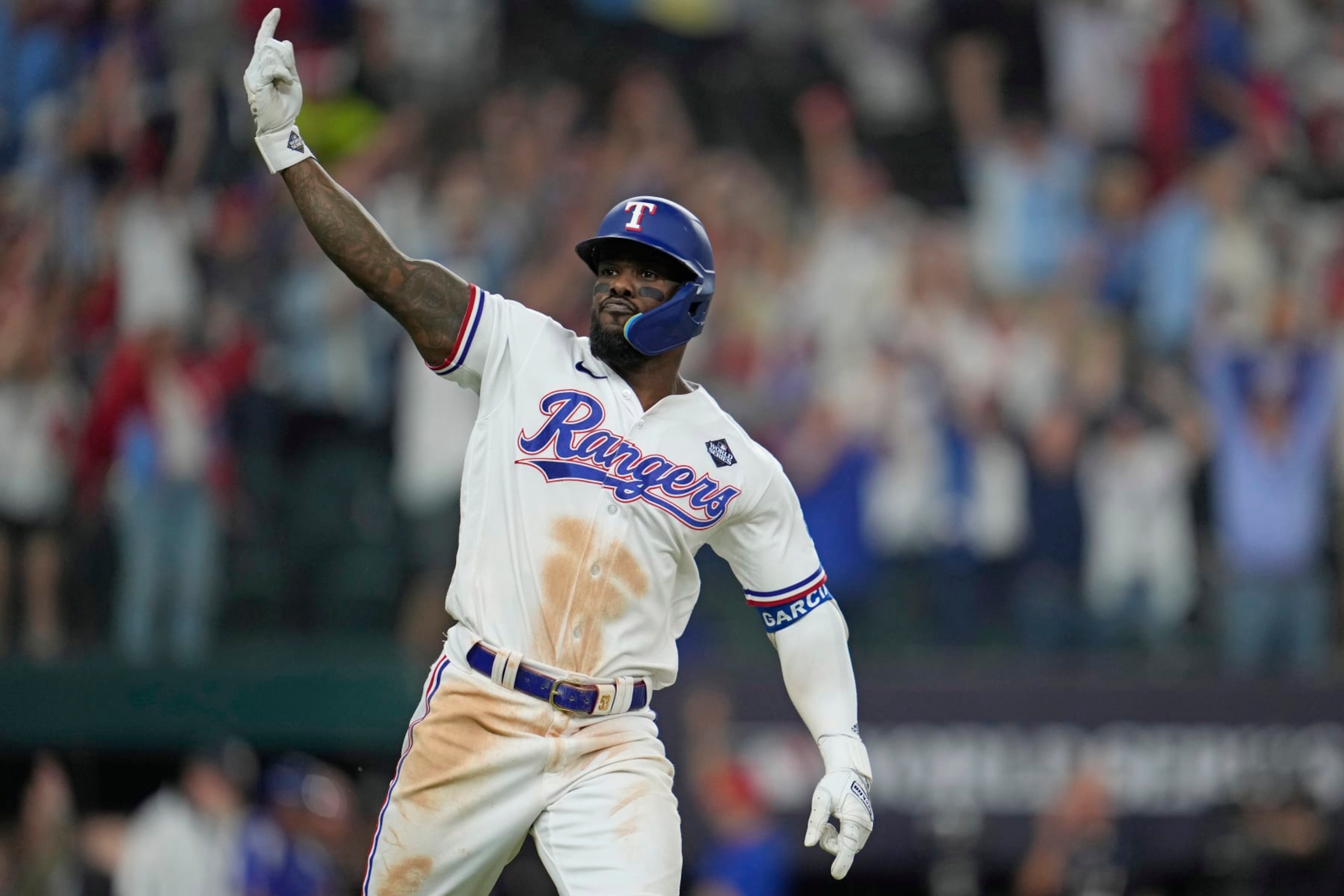 Texas Rangers' Adolis Garcia celebrates after hitting a game-winning home run against the Arizona Diamondbacks during the 11th inning in Game 1 of the baseball World Series Friday, Oct. 27, 2023, in Arlington, Texas. The Rangers won 6-5. (AP Photo/Godofredo A. Vásquez)