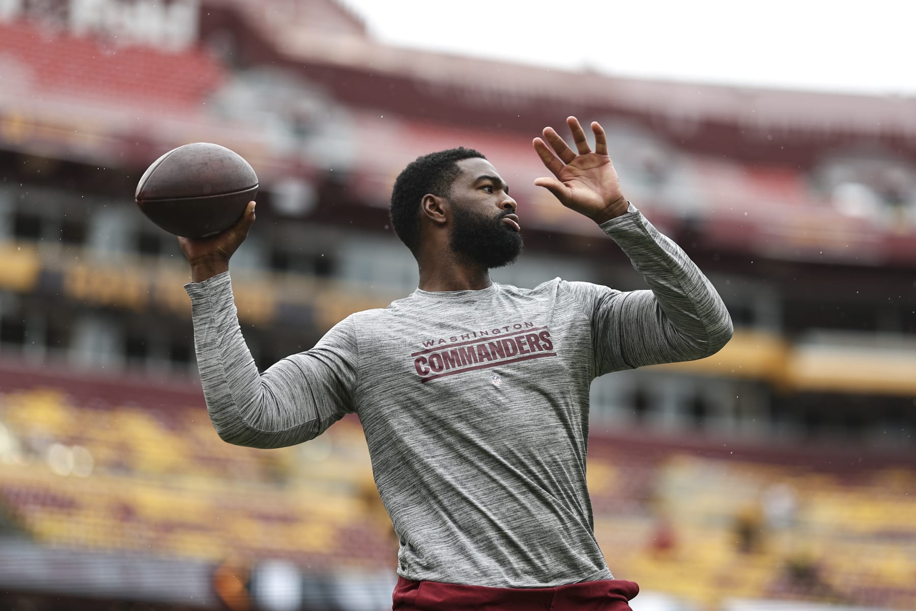 LANDOVER, MARYLAND - SEPTEMBER 10: Jacoby Brissett #12 of the Washington Commanders passes as he warms up prior to a game between the Washington Commanders and the Arizona Cardinals at FedExField on September 10, 2023 in Landover, Maryland. (Photo by Michael Owens/Getty Images)