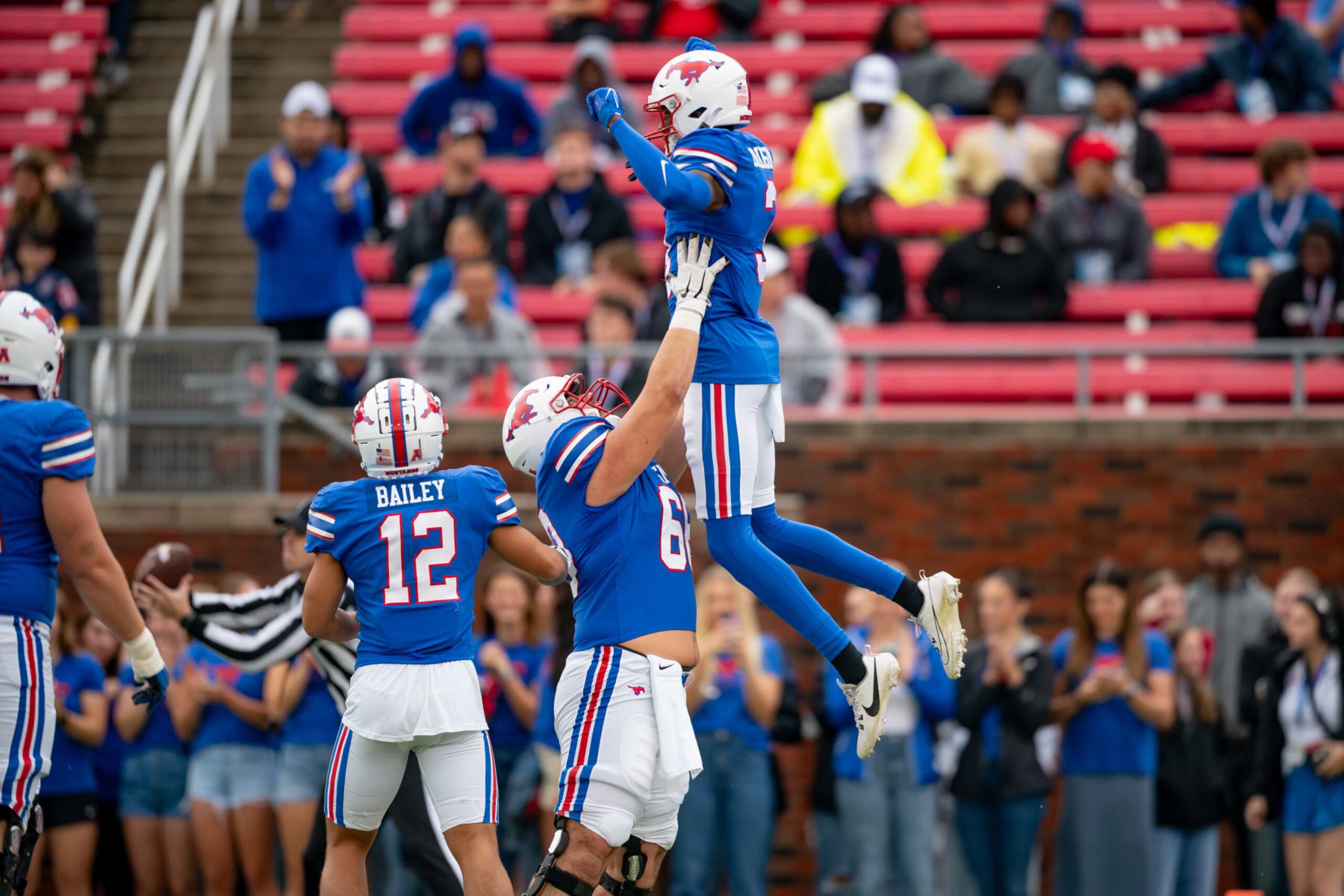 DALLAS, TX - OCTOBER 28: Southern Methodist Mustangs wide receiver Romello Brinson (3) is lifted by Southern Methodist Mustangs offensive lineman Jackson Ritz (68) after a touchdown during a game between the Tulsa Golden Hurricane and the Southern Methodist Mustangs on October 28, 2023, at Gerald Ford Stadium in Dallas, TX. (Photo by Chris Leduc/Icon Sportswire via Getty Images)