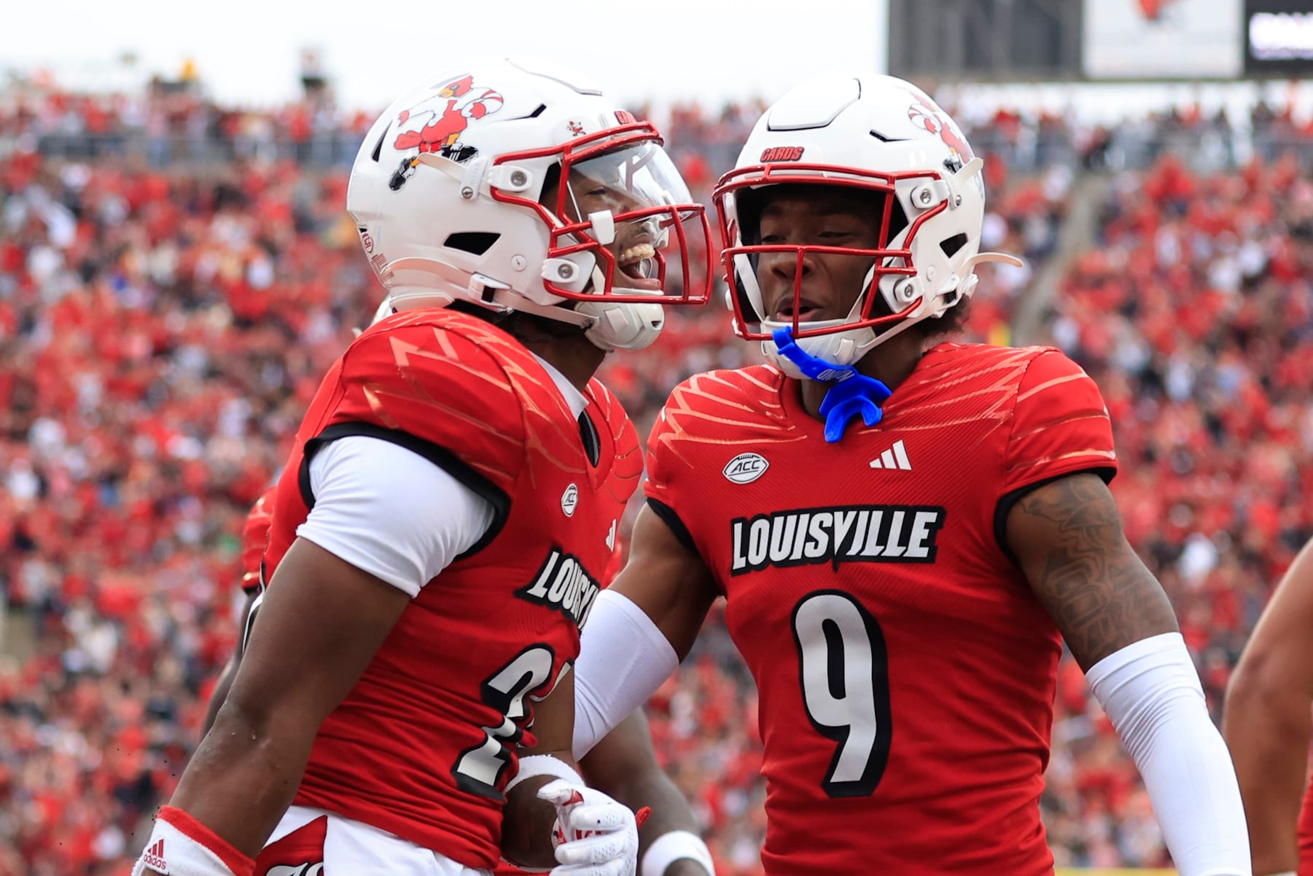 LOUISVILLE, KENTUCKY - OCTOBER 28: Jawhar Jordan #25 of the Louisville Cardinals celebrates a touchdown with Ahmari Huggins-Bruce #9 during the first half in the game against the Duke Blue Devils at Cardinal Stadium on October 28, 2023 in Louisville, Kentucky. (Photo by Justin Casterline/Getty Images)