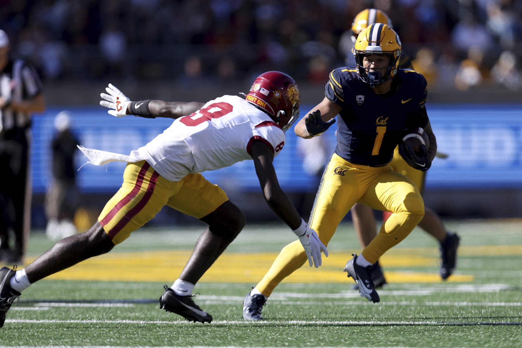 California running back Jaydn Ott (1) runs against Southern California linebacker Raesjon Davis (9) during the first half of an NCAA college football game in Berkeley, Calif., Saturday, Oct. 28, 2023. (AP Photo/Jed Jacobsohn)
