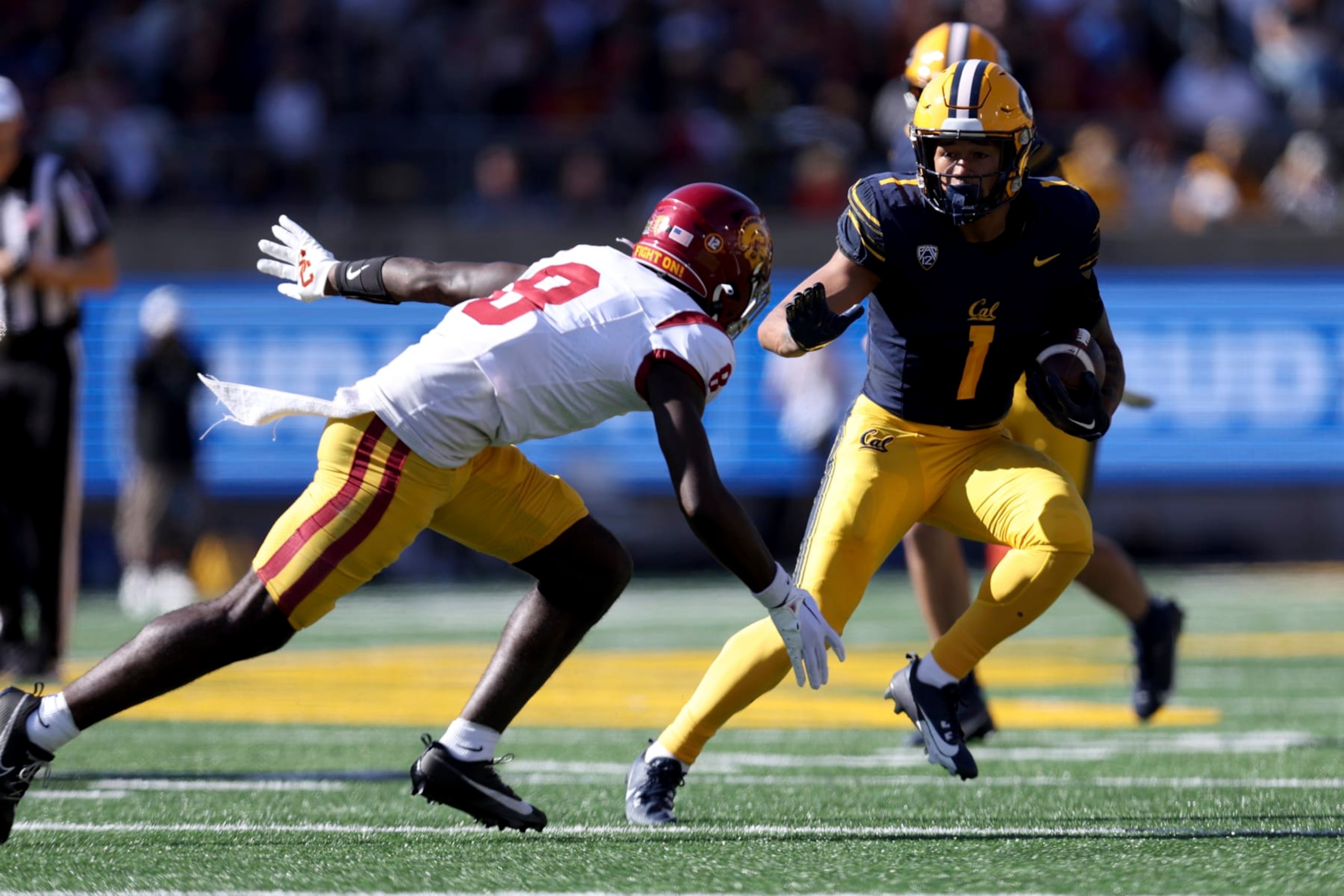 California running back Jaydn Ott (1) runs against Southern California linebacker Raesjon Davis (9) during the first half of an NCAA college football game in Berkeley, Calif., Saturday, Oct. 28, 2023. (AP Photo/Jed Jacobsohn)