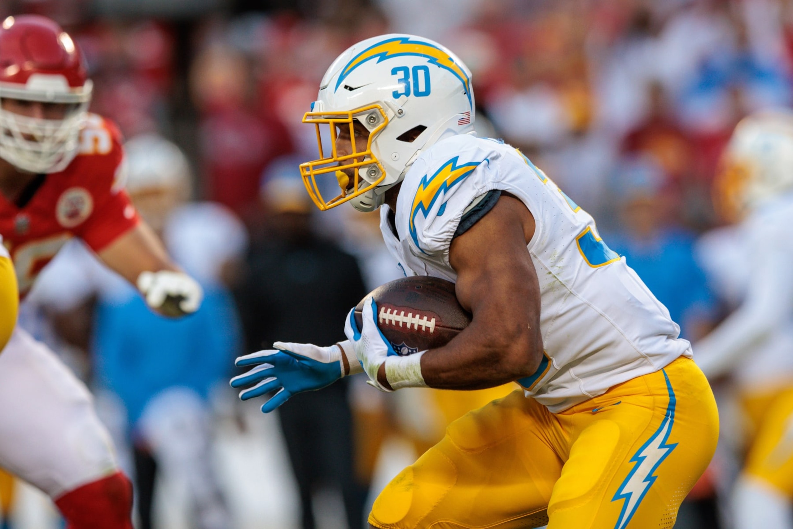 KANSAS CITY, MO - OCTOBER 22: Los Angeles Chargers running back Austin Ekeler (30) runs the ball during the second half against the Kansas City Chiefs on October 22, 2023 at GEHA Field at Arrowhead Stadium in Kansas City, Missouri. (Photo by William Purnell/Icon Sportswire via Getty Images)