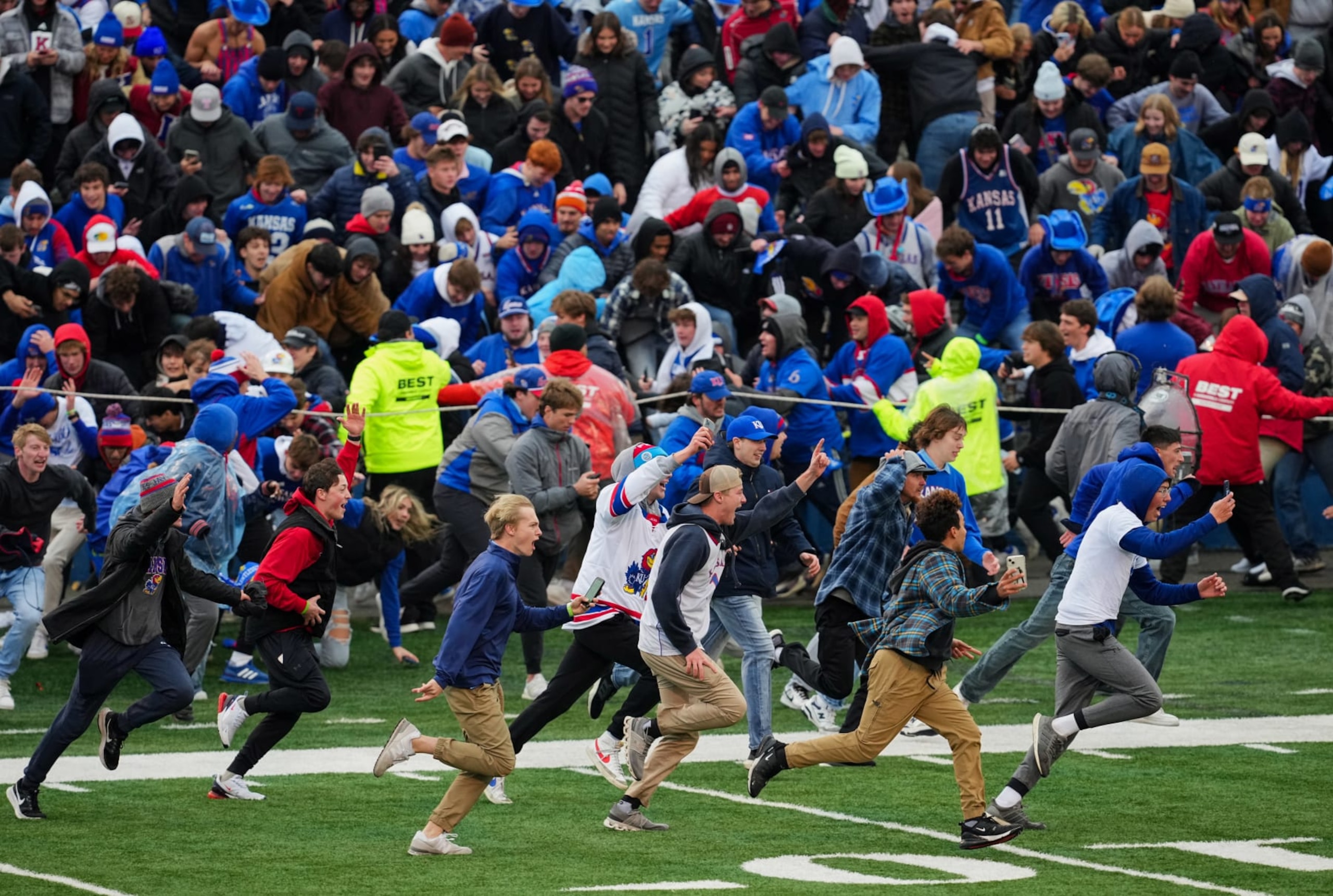 Kansas Jayhawks fans rush the field after defeating the Oklahoma Sooners Kansas Jayhawks fans rush the field after defeating the Oklahoma Sooners