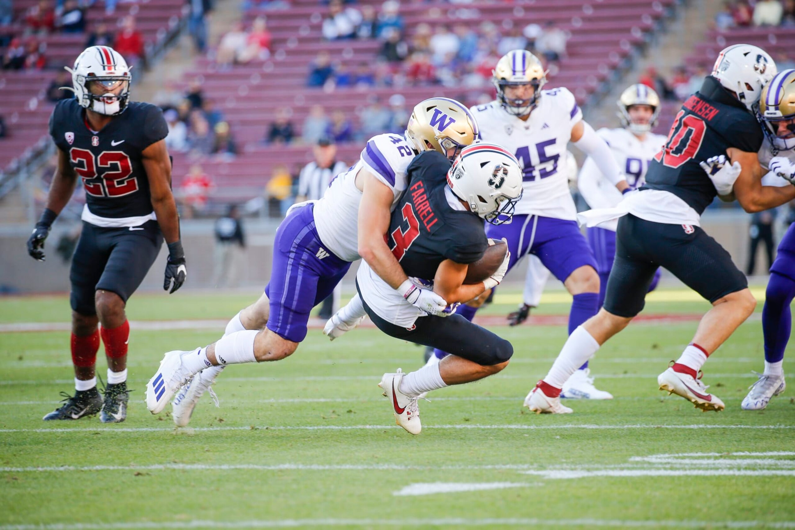 PALO ALTO, CA - OCTOBER 28: Stanford Cardinal WR Bryce Farrell (3) gets drilled hard by Washington Huskies LB Carson Bruener (42) in the game between the Washington Huskies and the Stanford Cardinal on October 28, 2023 at Stanford Stadium in Palo Alto, CA. (Photo by Larry Placido/Icon Sportswire via Getty Images)