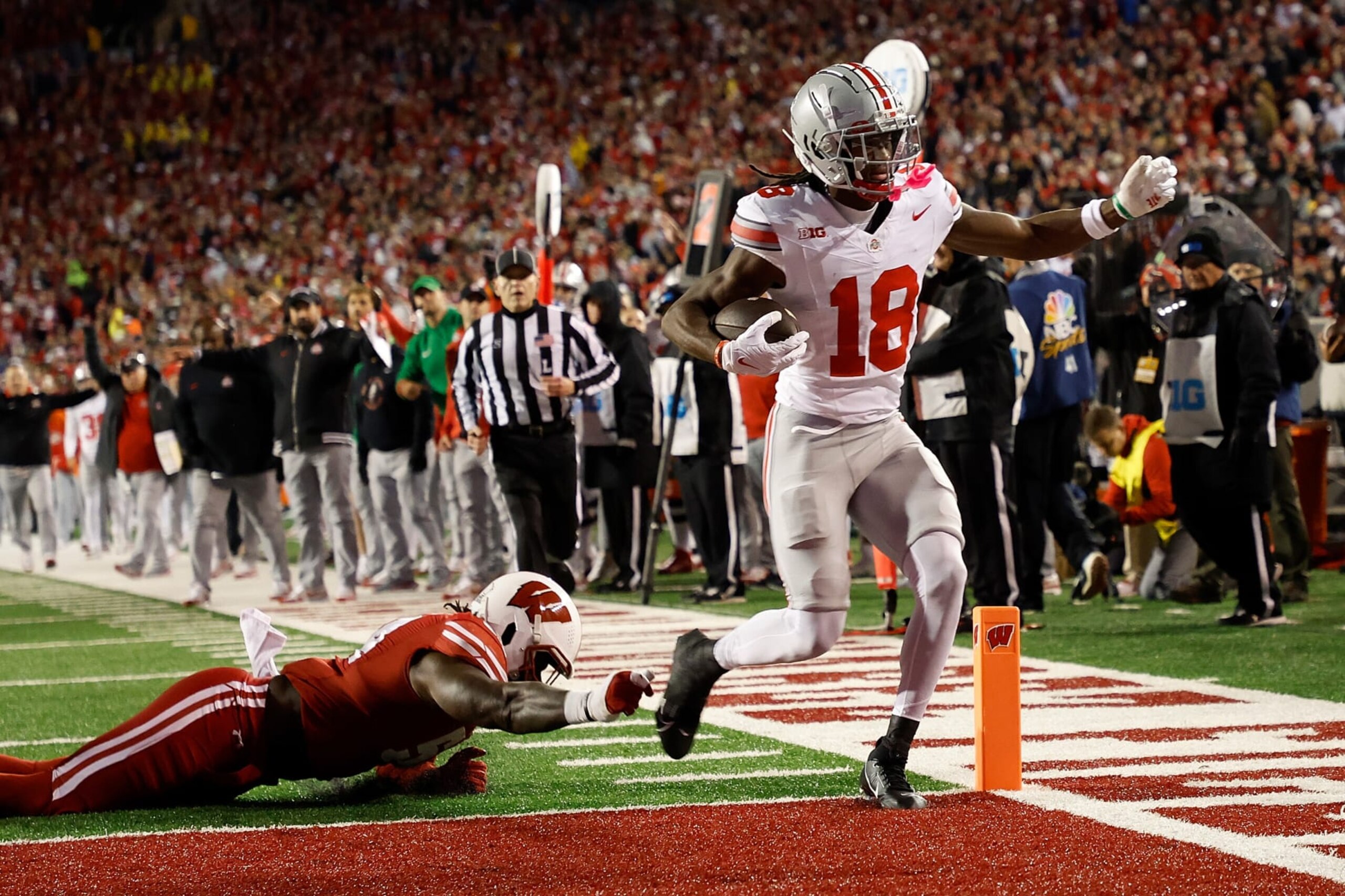 MADISON, WISCONSIN - OCTOBER 28: Marvin Harrison Jr. #18 of the Ohio State Buckeyes scores on a 16 yard touchdown pass during the second quarter against the Wisconsin Badgers at Camp Randall Stadium on October 28, 2023 in Madison, Wisconsin. (Photo by John Fisher/Getty Images)