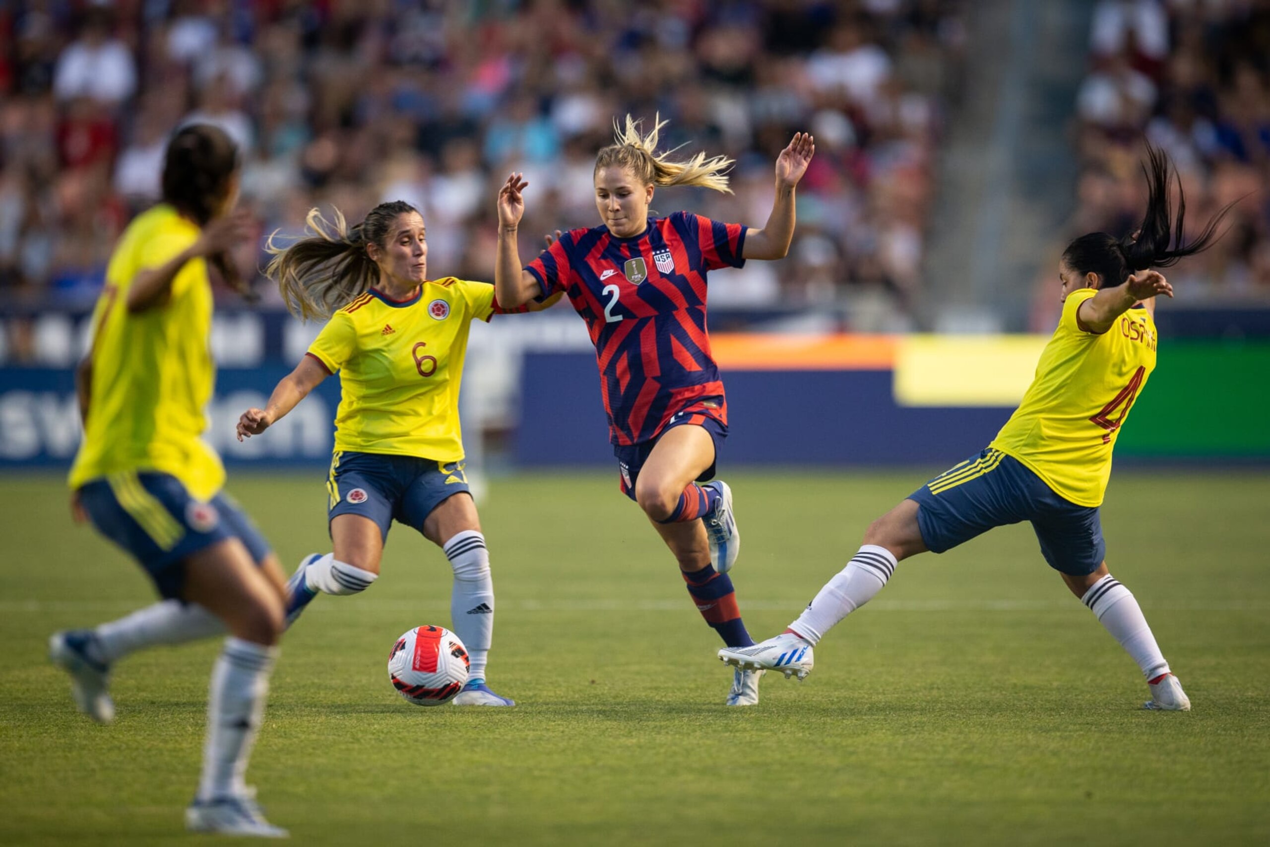 SANDY, UT - JUNE 28: Ashley Sanchez #2 of the United States dribbles through Daniela Montoya #6 and Diana Ospina #4 of Colombia during a game between Colombia and USWNT at Rio Tinto Stadium on June 28, 2022 in Sandy, Utah. (Photo by Erin Chang/ISI Photos/Getty Images)