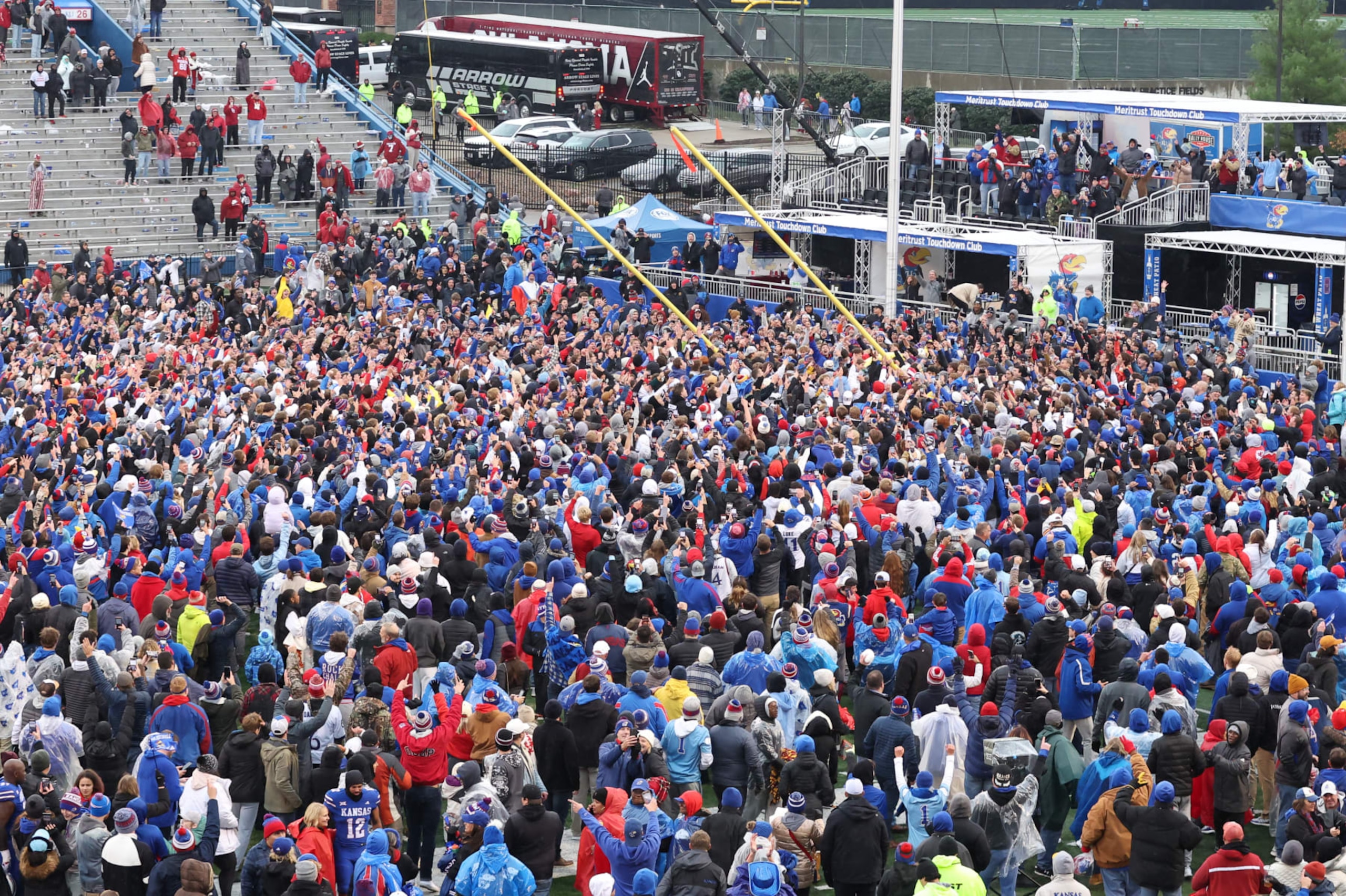 LAWRENCE, KS - OCTOBER 28: Kansas Jayhawks fans climb the goal posts to take them down after defeating the Oklahoma Sooners on Oct 28, 2023 at Memorial Stadium in Lawrence, KS.  (Photo by Scott Winters/Icon Sportswire via Getty Images)