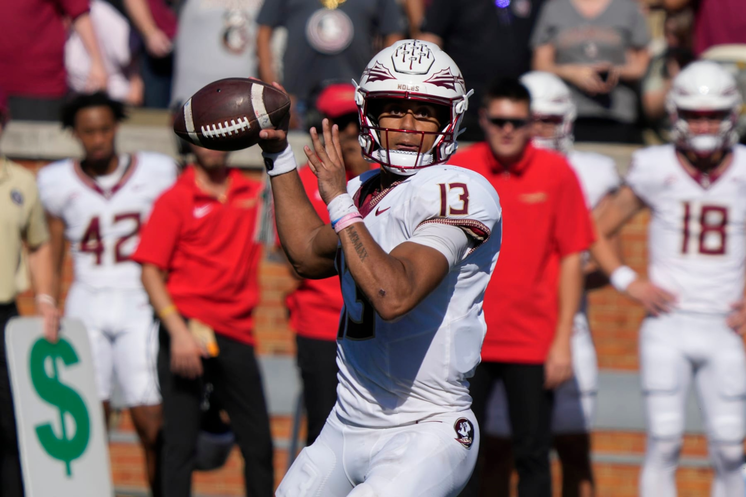 Florida State quarterback Jordan Travis (13) looks to pass against Wake Forest during the second half of an NCAA college football game in Winston-Salem, N.C., Saturday, Oct. 28, 2023. (AP Photo/Chuck Burton)