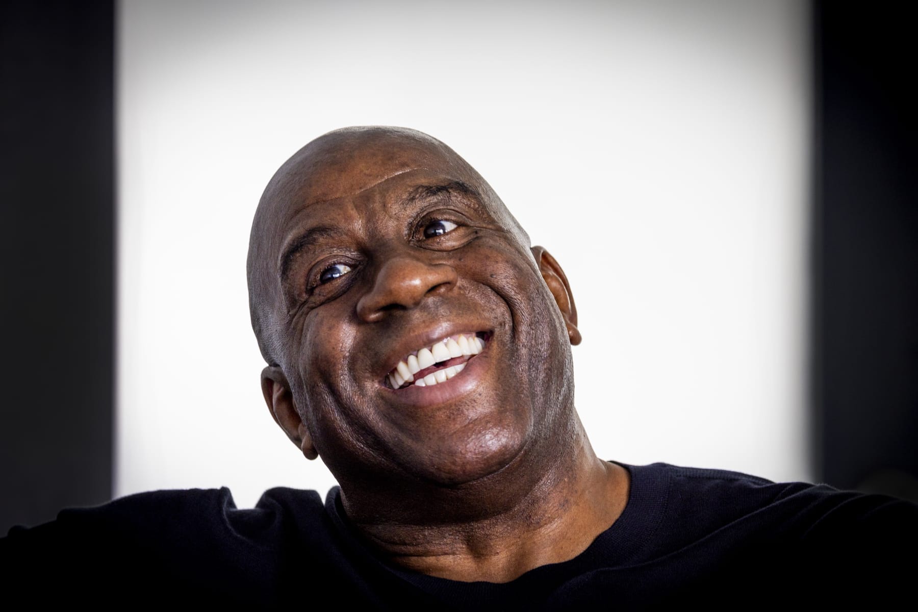 Los Angeles, CA - October 17: Lakers legend Earvin "Magic" Johnson talks to a Los Angeles Times reporter during an interview before he and GSK were joined by healthcare professionals and patient advocates to educate and raise awareness on the risk of Respiratory Syncytial Virus (RSV) infection for people 60 years of age and older at the Crenshaw Family YMCA in Los Angeles Tuesday, Oct. 17, 2023.  (Allen J. Schaben / Los Angeles Times via Getty Images)