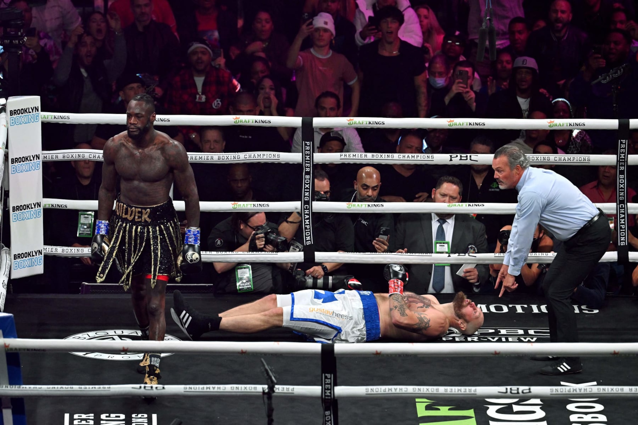 US boxer Deontay Wilder (R) knocks out Swedish-Finnish boxer Robert Helenius in the 1st round of their 12-round WBC World Heavyweight Title Eliminator fight at Barclays Center in Brooklyn, New York, on October 15, 2022. (Photo by ANGELA WEISS / AFP) (Photo by ANGELA WEISS/AFP via Getty Images)