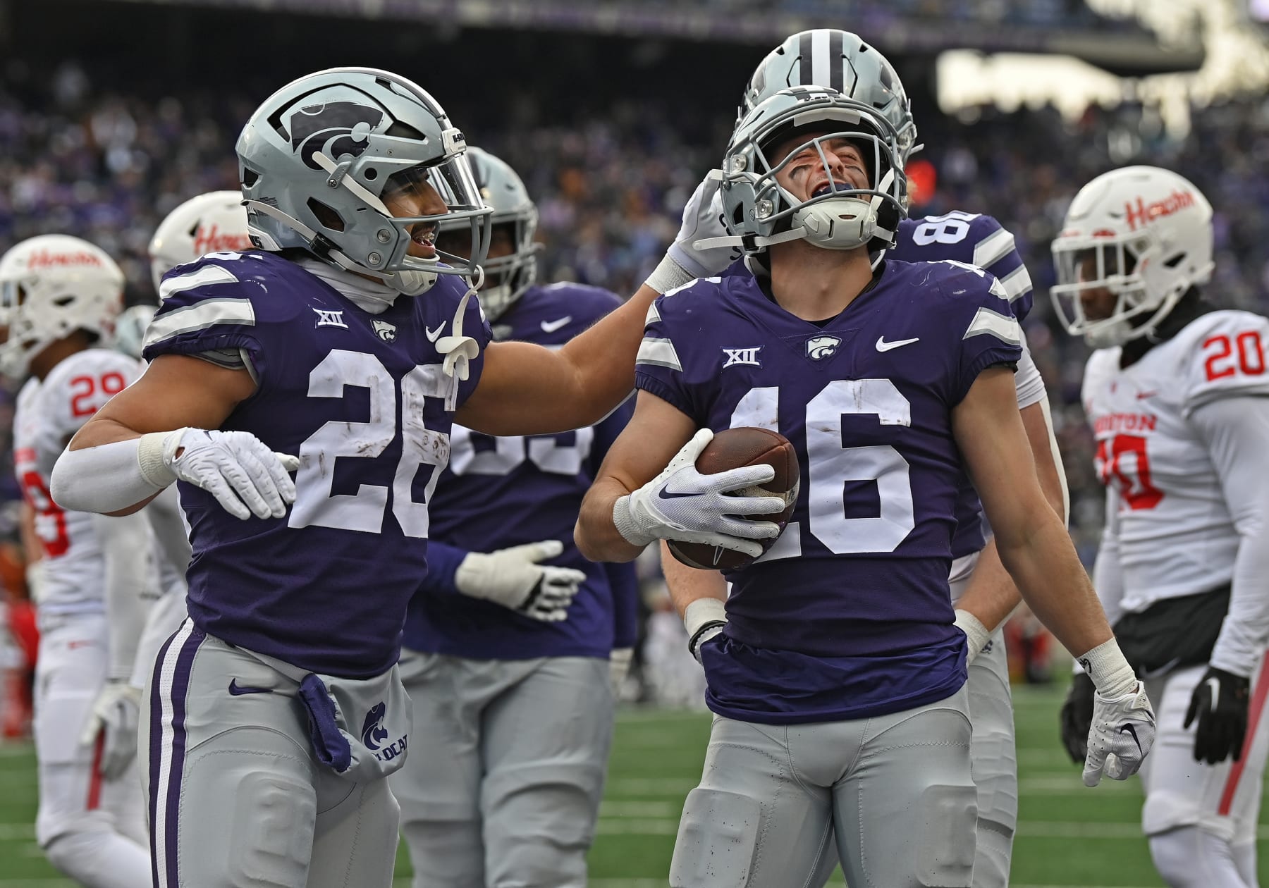 MANHATTAN, KS - OCTOBER 28: Seth Porter #16 of the Kansas State Wildcats celebrates with Anthony Frias II #26 after scoring a touchdown in the second half against the Houston Cougars at Bill Snyder Family Football Stadium on October 28, 2023 in Manhattan, Kansas. (Photo by Peter Aiken/Getty Images)