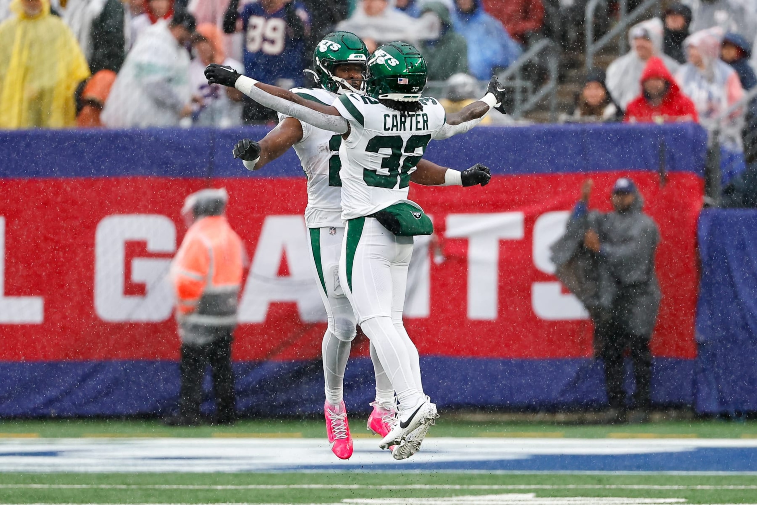 EAST RUTHERFORD, NJ - OCTOBER 29:  Breece Hall (20) of the New York Jets celebrates woth Michael Carter (32) after he scores a touchdown  against the New York Giants on October 29, 2023 at MetLife Stadium in East Rutherford, New Jersey.  (Photo by Rich Graessle/Icon Sportswire via Getty Images)