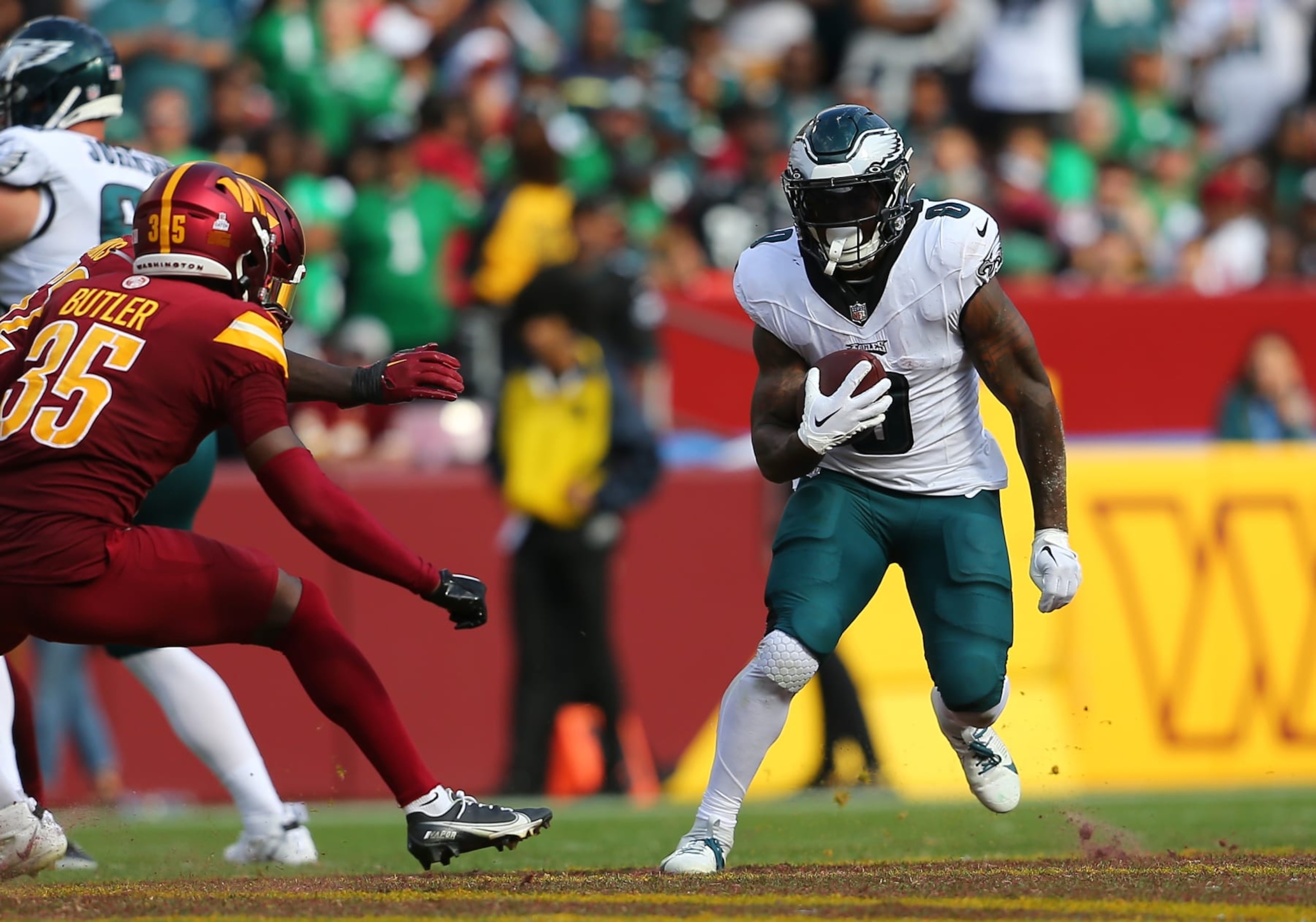 LANDOVER, MD - OCTOBER 29: Philadelphia Eagles running back D'Andre Swift (0) rushes up field attempting to elude Washington Commanders defensive back Percy Butler (35) during the Philadelphia Eagles game versus the Washington Commanders on October 29, 2023, at FedEx Field in Landover, MD. (Photo by Lee Coleman/Icon Sportswire via Getty Images)