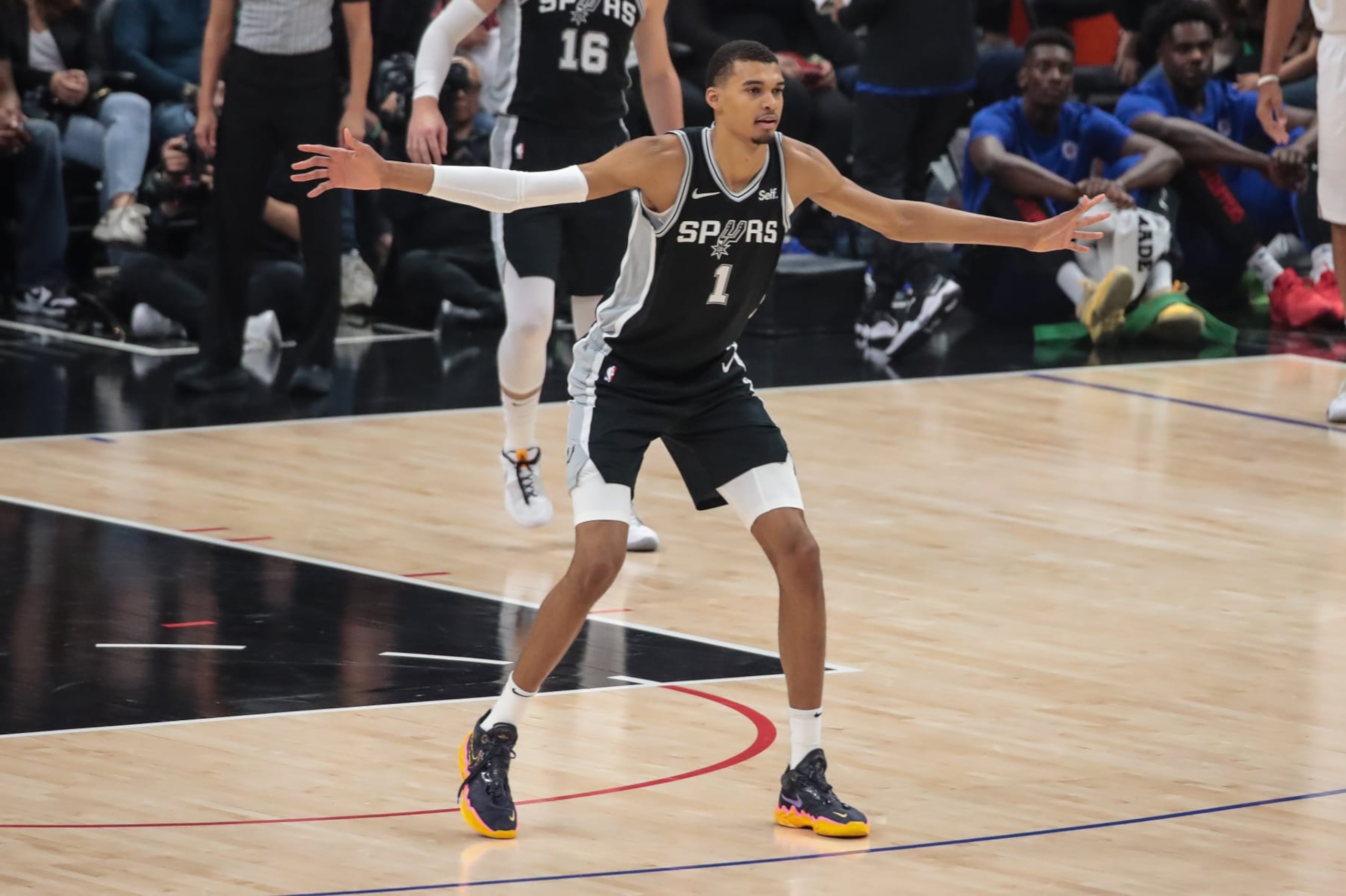 LOS ANGELES, CA - OCTOBER 29: San Antonio Spurs center Victor Wembanyama (1) shows his wingspan during the San Antonio Spurs game versus the Los Angeles Clippers on October 29, 2023, at Crypto.com Arena in Los Angeles, CA. (Photo by Jevone Moore/Icon Sportswire via Getty Images)