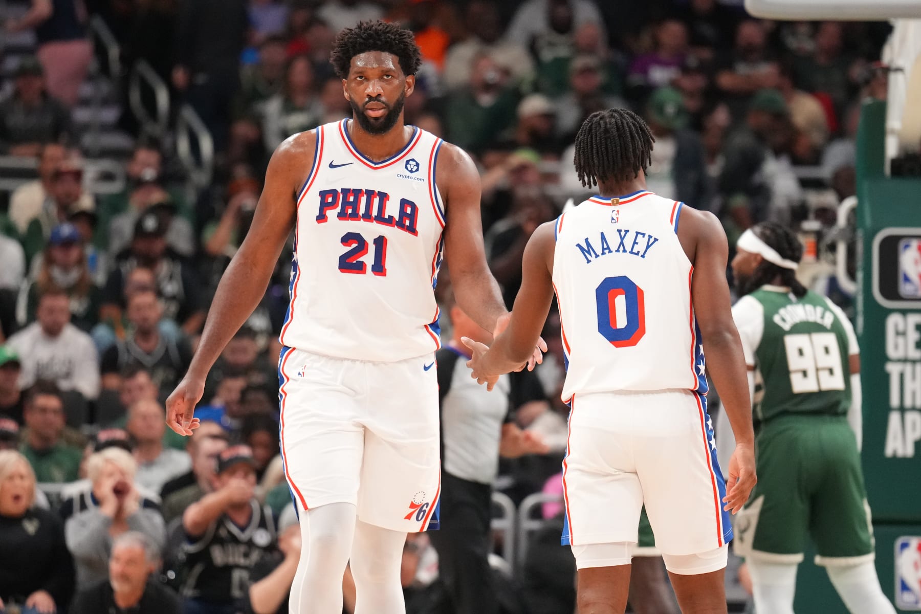 MILWAUKEE, WI - OCTOBER 26: Joel Embiid #21 high fives Tyrese Maxey #0 of the Philadelphia 76ers during the game against the Milwaukee Bucks on October 26, 2023 at the Fiserv Forum Center in Milwaukee, Wisconsin. NOTE TO USER: User expressly acknowledges and agrees that, by downloading and or using this Photograph, user is consenting to the terms and conditions of the Getty Images License Agreement. Mandatory Copyright Notice: Copyright 2023 NBAE (Photo by Jesse D. Garrabrant/NBAE via Getty Images).