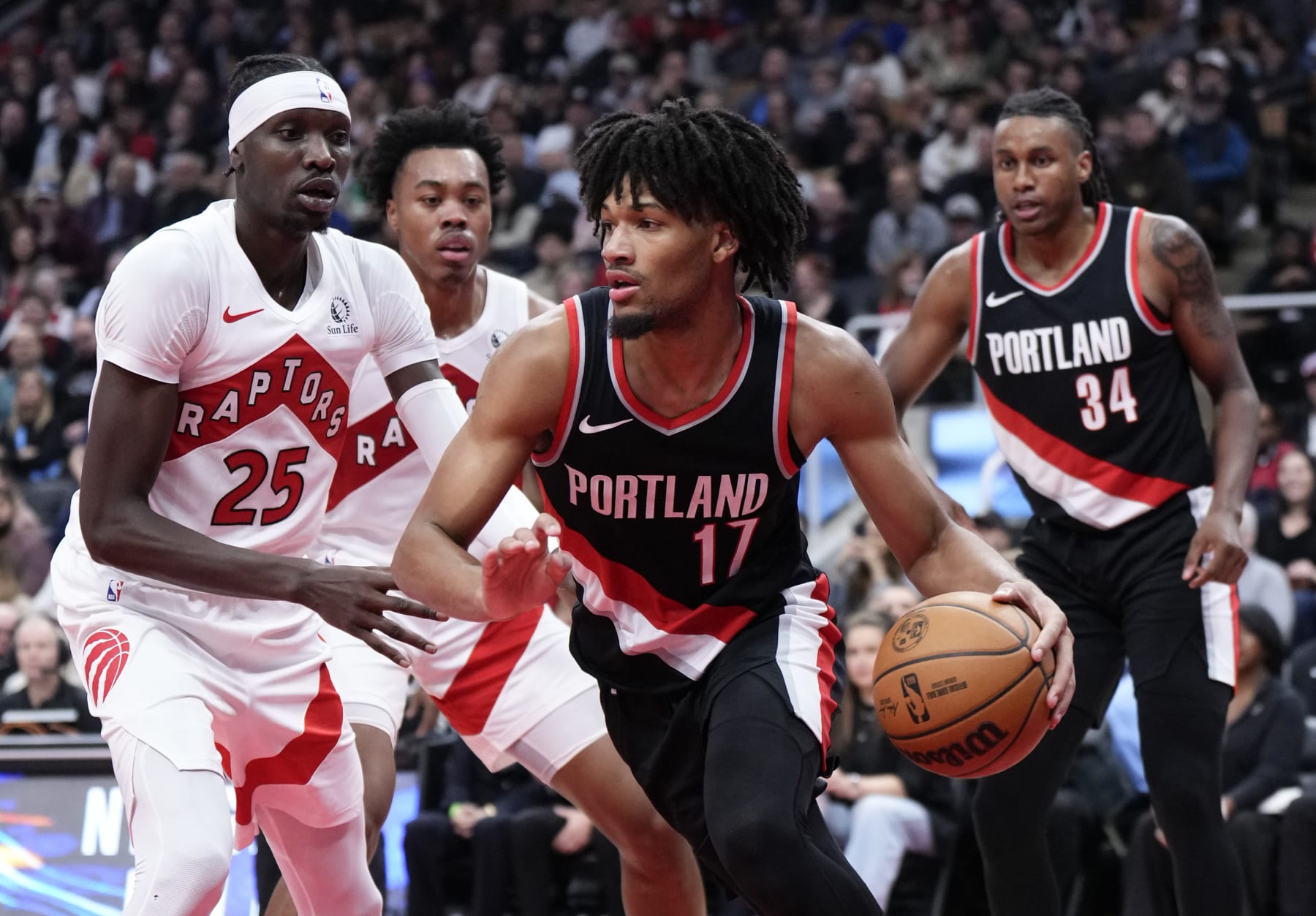 TORONTO, ON - OCTOBER 30: Shaedon Sharpe #17 of the Portland Trail Blazers dribbles against Chris Boucher #25 of the Toronto Raptors during the first half of their basketball game at the Scotiabank Arena on October 30, 2023 in Toronto, Ontario, Canada. NOTE TO USER: User expressly acknowledges and agrees that, by downloading and/or using this Photograph, user is consenting to the terms and conditions of the Getty Images License Agreement. (Photo by Mark Blinch/Getty Images)