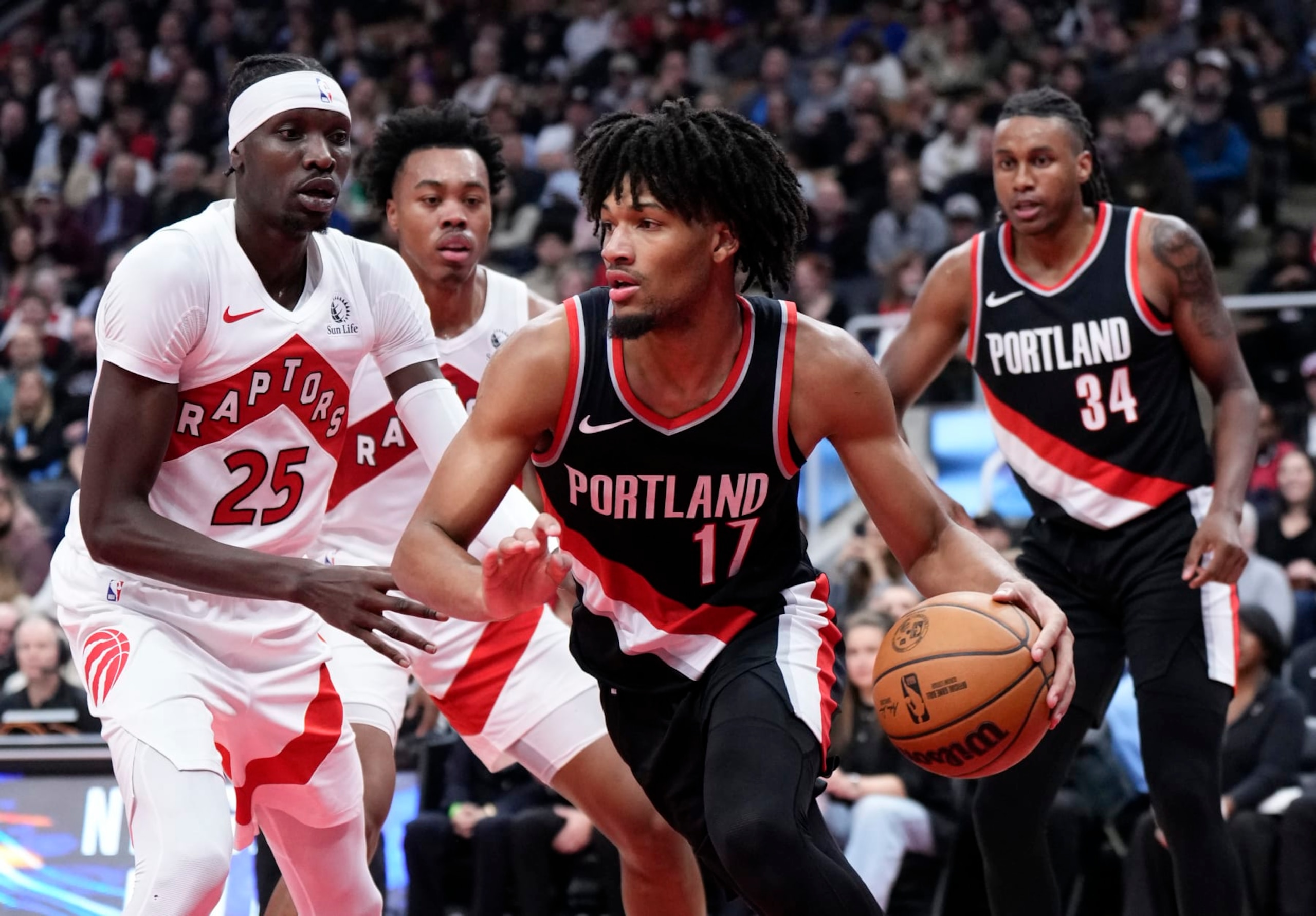 TORONTO, ON - OCTOBER 30: Shaedon Sharpe #17 of the Portland Trail Blazers dribbles against Chris Boucher #25 of the Toronto Raptors during the first half of their basketball game at the Scotiabank Arena on October 30, 2023 in Toronto, Ontario, Canada. NOTE TO USER: User expressly acknowledges and agrees that, by downloading and/or using this Photograph, user is consenting to the terms and conditions of the Getty Images License Agreement. (Photo by Mark Blinch/Getty Images)