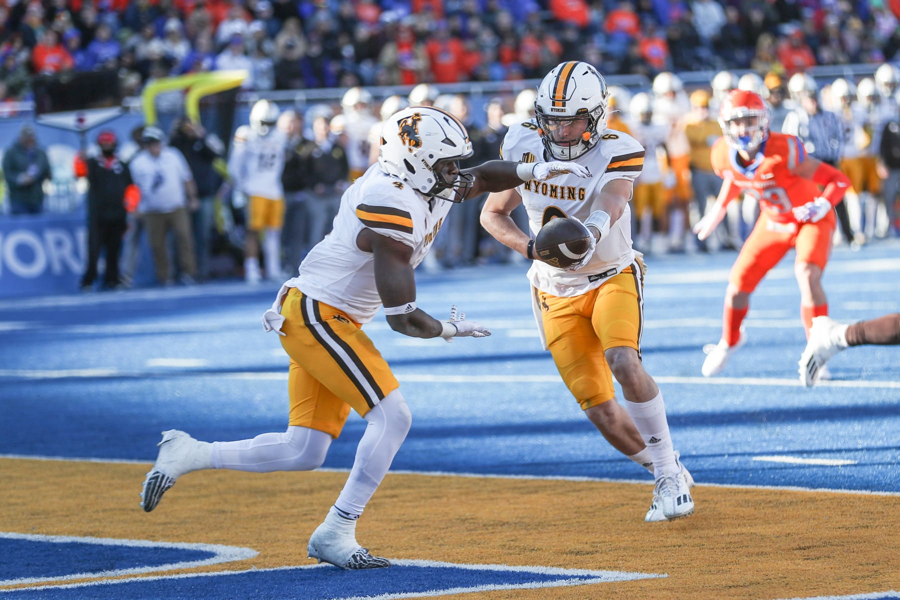 BOISE, ID - OCTOBER 28: Quarterback Andrew Peasley #6 of the Wyoming Cowboys hands the ball off to running back Harrison Waylee #4 during the first half against the Boise State Broncos at Albertsons Stadium on October 28, 2023 in Boise, Idaho. (Photo by Loren Orr/Getty Images)
