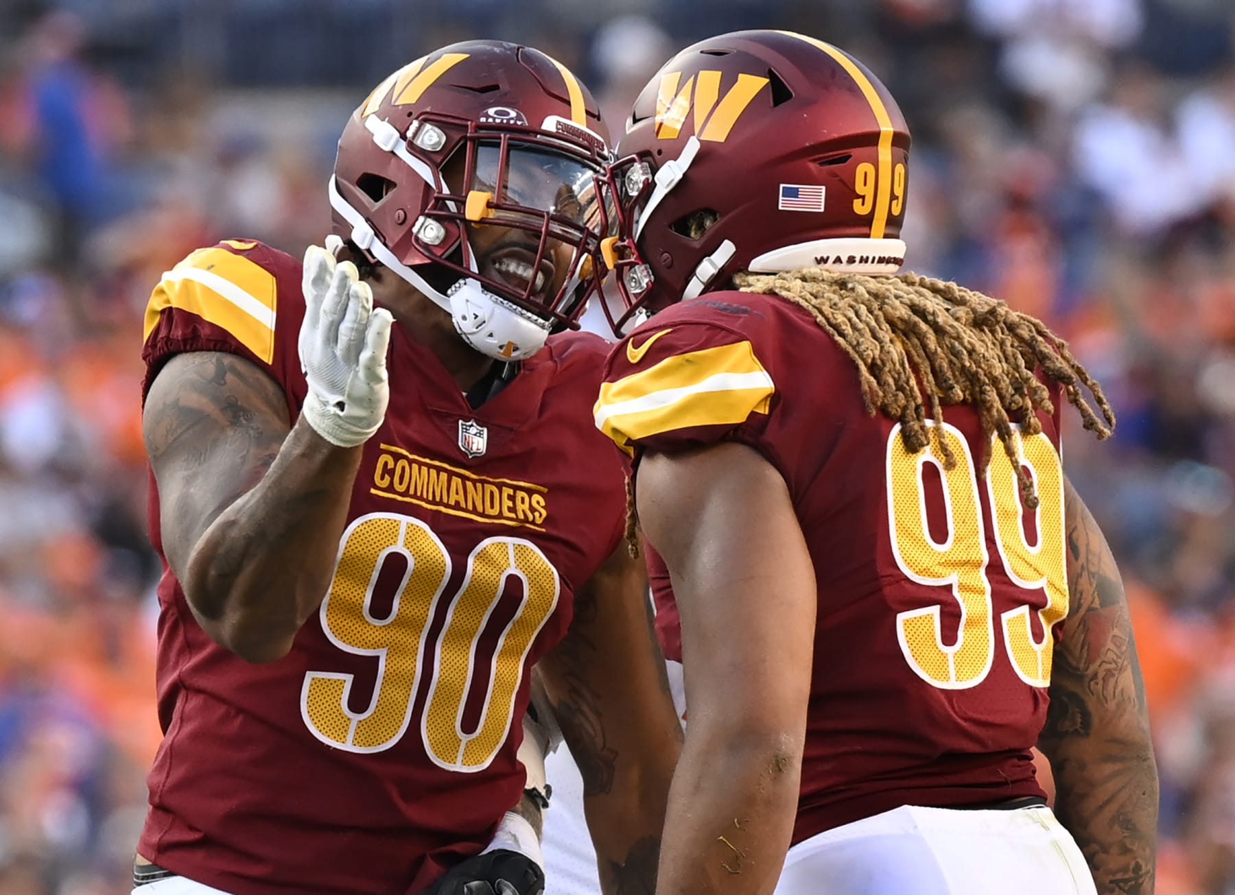 DENVER, CO - SEPTEMBER 17:Washington Commanders defensive end Montez Sweat (90), left, celebrate a shared late 4th quarter sack of Broncos quarterback Russell Wilson  with fellow defensive end Chase Young (99) during the Washington Commanders defeat of the Denver Broncos 35-33 at Empower Field at Mile High in Denver, CO on September 17, 2023. (Photo by John McDonnell/The Washington Post via Getty Images)