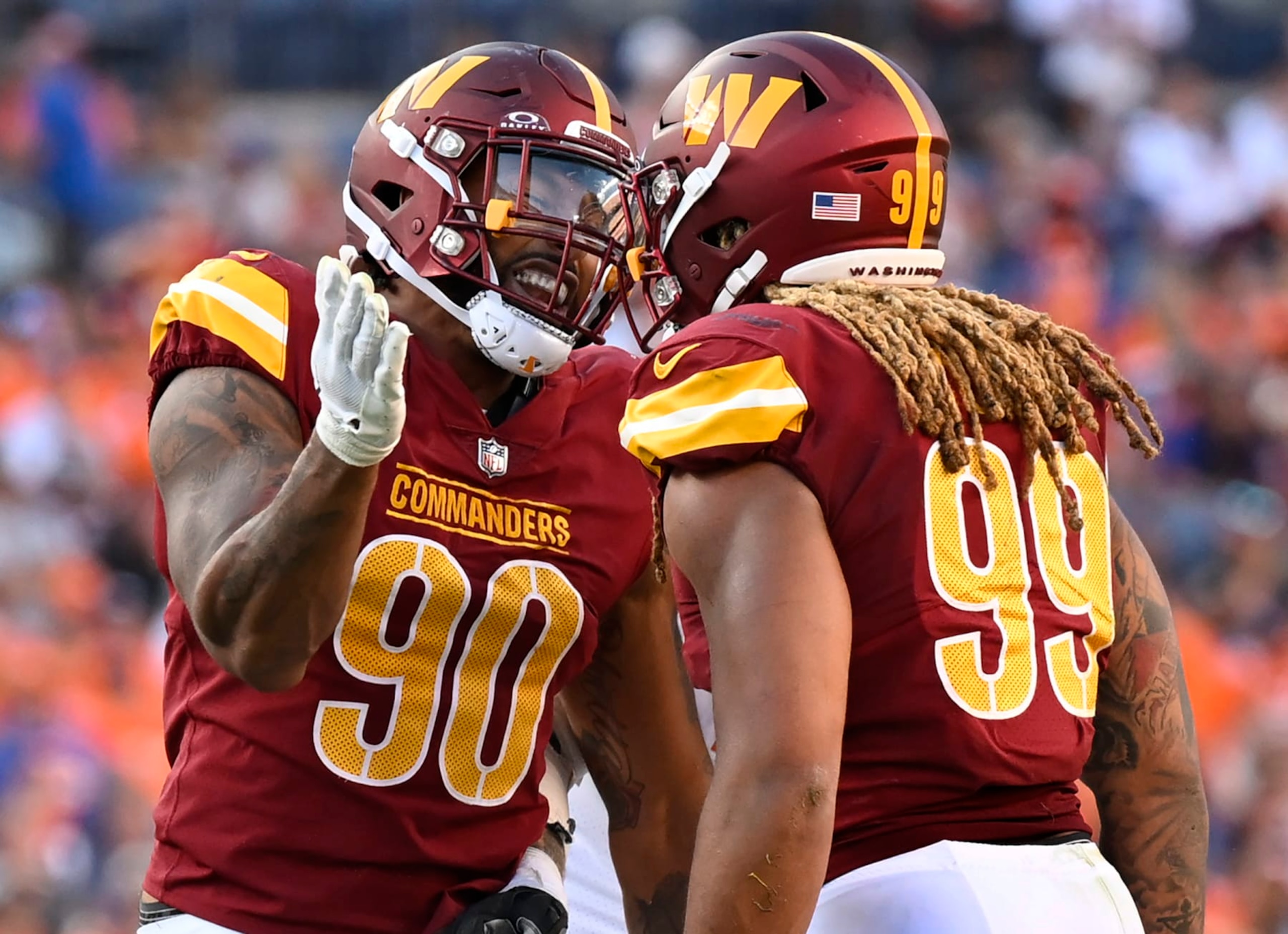 DENVER, CO - SEPTEMBER 17:Washington Commanders defensive end Montez Sweat (90), left, celebrate a shared late 4th quarter sack of Broncos quarterback Russell Wilson  with fellow defensive end Chase Young (99) during the Washington Commanders defeat of the Denver Broncos 35-33 at Empower Field at Mile High in Denver, CO on September 17, 2023. (Photo by John McDonnell/The Washington Post via Getty Images)